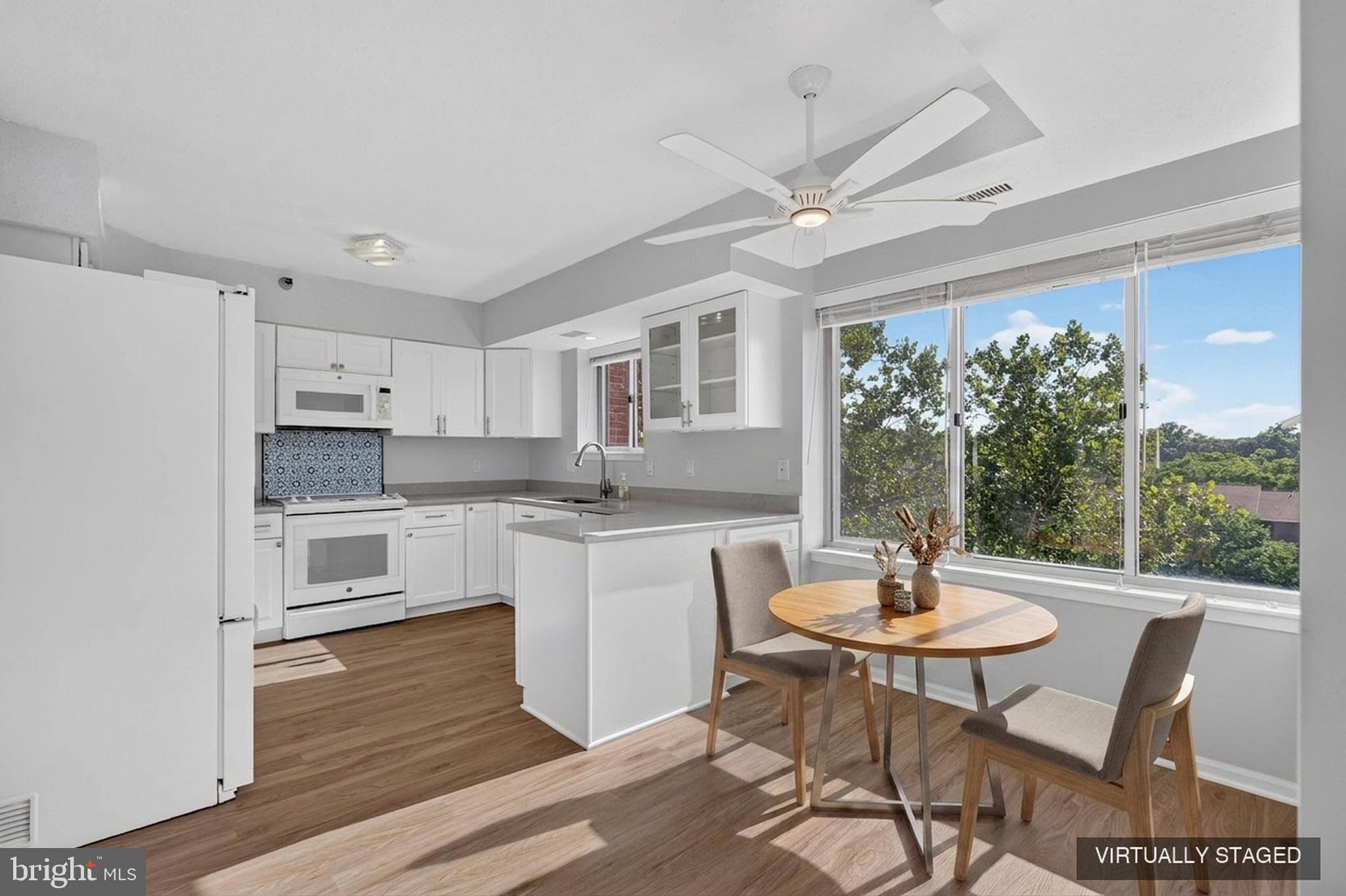 Welcome to 2-602 at The Fallswood — an updated 3-bedroom, 2-bathroom condo tucked into the trees of North Bethesda, where 1,630 square feet of single-level living feels every bit like a house.  From the moment you open the door of this corner unit, you see a beautiful tree off the large terrace. The updated kitchen, with the area for a table and chairs, really does feel like a single family home kitchen.  Brand new flooring runs throughout the entire condo, tying every room together with one clean, cohesive look.  The primary suite features a fully renovated, spa-inspired bathroom — a frameless glass walk-in shower and walk-in closet. The second bathroom has also been updated, with a navy vanity, brass fixtures, and a fresh marble-look counter, serving the two additional bedrooms — one of which works just as easily as a home office or guest room. And just off the kitchen, a true walk-in laundry room with a full-size washer and dryer — not a stackable in a tight closet, instantly makes doing laundry easier.  The condo also has two parking spaces (tandem) and a storage cage.  And the location can only be described as simply: Super Prime. You're one block from Whole Foods, three blocks from Pike & Rose and the North Bethesda Metro — restaurants, shopping, Pinstripes, all walkable. My Organic Market, Trader Joe's, Giant, and Aldi are also all within about a half mile, and the Shriver Aquatic Center (under a massive renovation) sits directly across the street.  Plus quick access to the Capital Crescent Trail, Beach Drive, Strathmore Music & Arts Center, and all the major roads.  The Fallswood rounds out the picture: a 24-hour front desk, gated security, a seasonal pool, tennis and pickleball court, a fitness room, library, party room, and Amazon lockers. And then there's the building's hidden gem — a massive, landscaped Sun Deck with multiple grills and lounge seating, tucked away enough to feel private, big enough to host. Grab dinner from Whole Foods, fire it up on the grill, and watch the sun go down without ever getting in a car! This is the lifestyle!