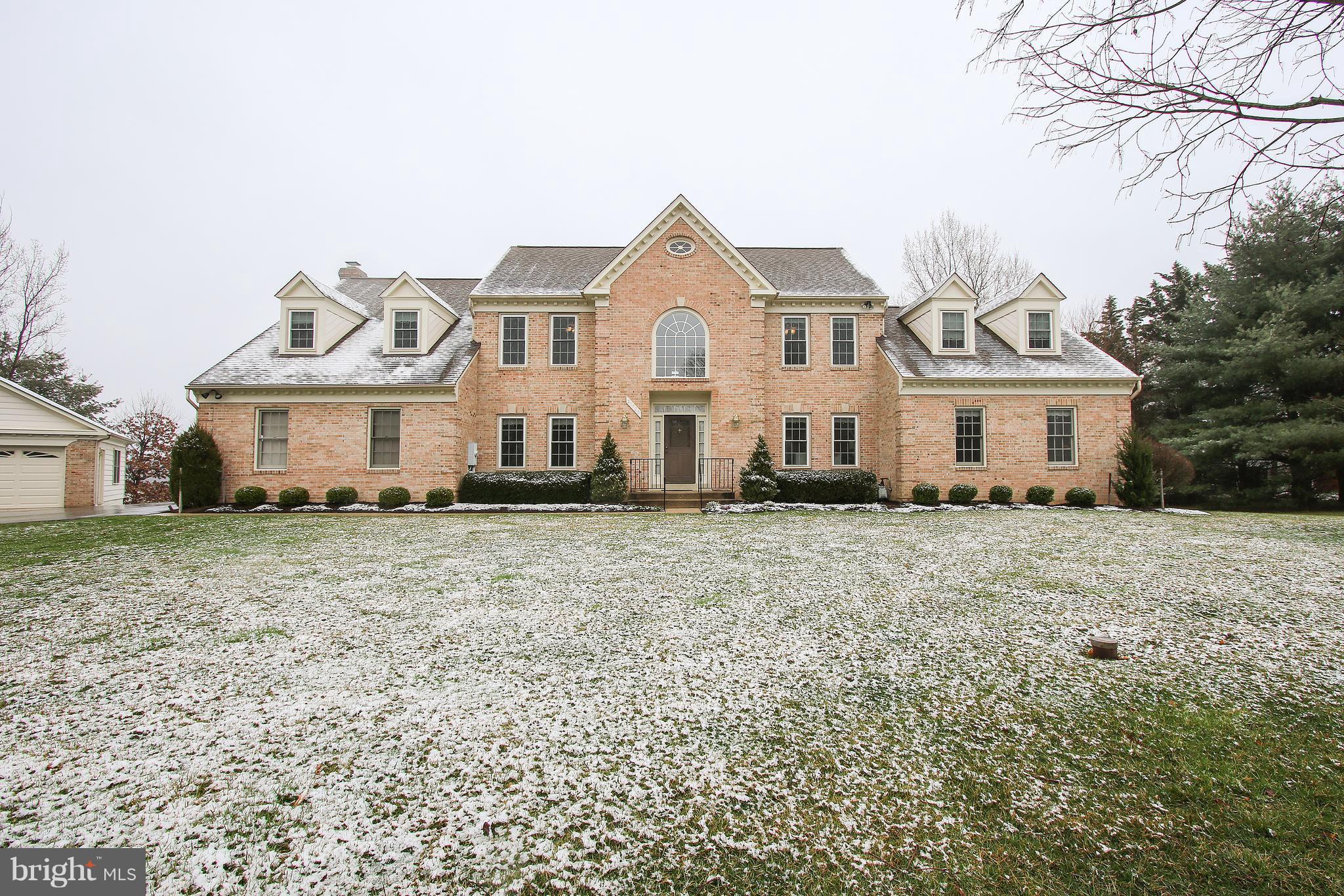 Lovely multi-generational home in excellent condition on almost two beautiful acres! Freshly painted w/ new carpet throughout, in law suite on main level w/ living area, BR & roll in shower.  Updated kitchen! Finished walk out basement. Beautiful Large Trex deck, newer Anderson vinyl windows. 2 car detached garage. 3 HVAC! Wheelchair accessible! Generous bedrooms and closet space. Move in ready!