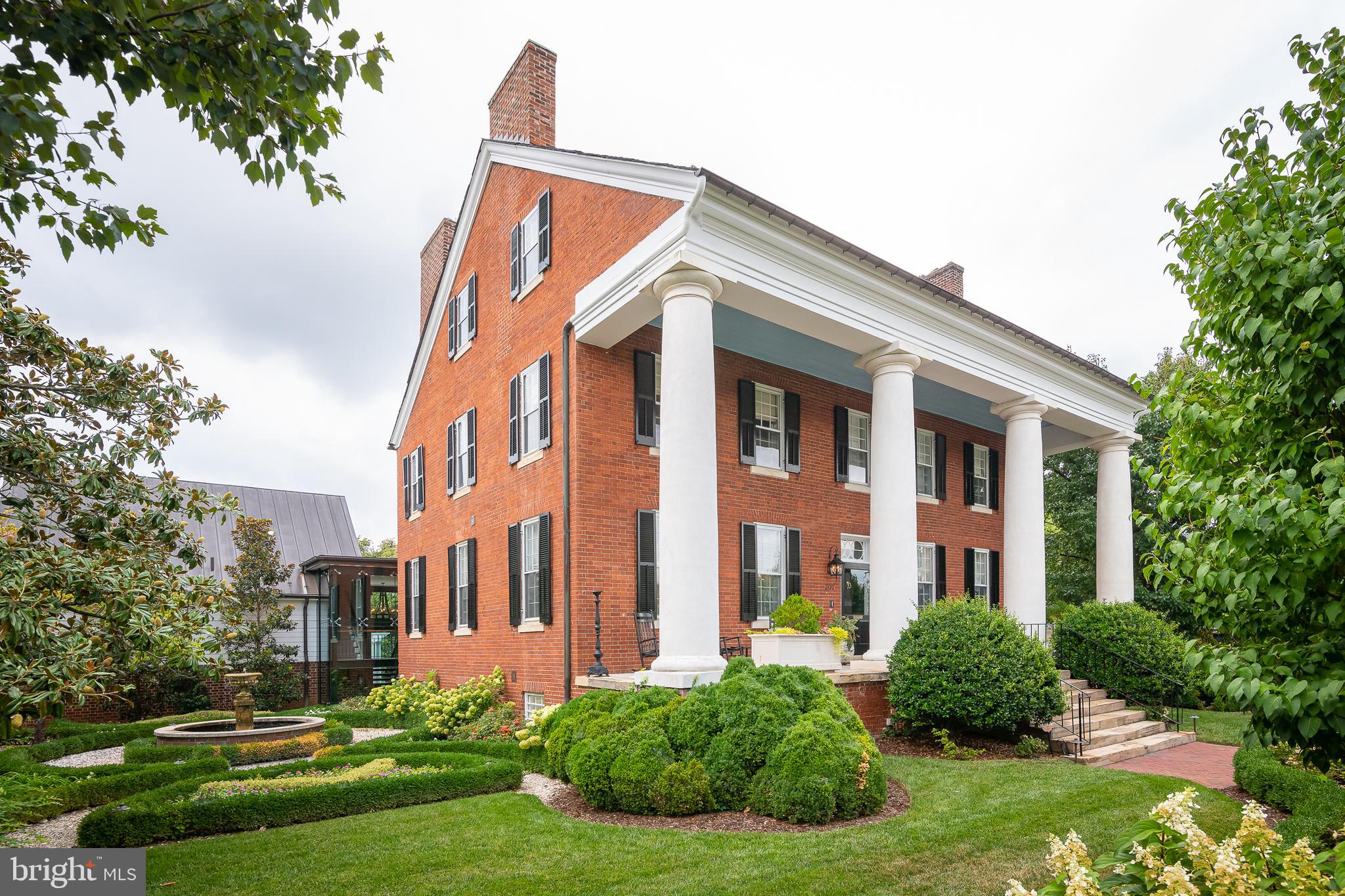 CONSTRUCTION ON BRAND NEW 2ND KITCHEN ON MAIN LEVEL HAS BEEN COMPLETED! 
 Welcome to Smithsonia! This stunning four columned historic landmark located right in the heart of Downtown Fredericksburg is back on the market, and this time with some extremely exciting upgrades!  The  existing kitchen in the lower level with an exposed wood beam ceiling remains,  giving the large home two luxurious kitchens. The existing kitchen is complete with custom cabinetry, a marble topped island and countertops, gas log fireplace, walk-in pantry, an off-kitchen sitting/dining area, a commercial Viking range, Sub Zero refrigerator, wine cooler, dishwasher, microwave, and more! Upstairs, when you are standing in the grand entry way of the home, there is an enormous ballroom perfect for entertaining to the left, and to the right is a formal dining area with a fireplace. Throughout the rest of this 9,000+ SF mansion, you will find six large bedrooms all with their own full bathrooms. The Master suite has an entire extra room as a closet/dressing area with an island, and is also complete with a soaking tub, two more built in closets, his and her sinks, and a glassed-in shower. A 3-car garage with a full gym above it connects to the home through a stunning two-story glass atrium. Downstairs there is a large recreation area perfect for hanging out with the family or entertaining. The home is climate controlled thru a geothermal system which drastically reduces monthly bills.  Moving to the exterior, you'll notice a gorgeous fountain on the side of the house, a solarium opposite the fountain, a long pergola separating the driveway and yard, a gazebo in the back, a brick patio and walkways, a brick wall surrounding the whole home, and stunning landscaping! Other features include an elevator that services three levels, five fireplaces, the original staircase, custom trim, wood floors, tall ceilings, window shutters, a soon-to-be installed electric gate to the driveway, and much more. Only a few blocks from all of Fredericksburg's plethora of dining and shopping amenities. Come see everything this house has to offer today!