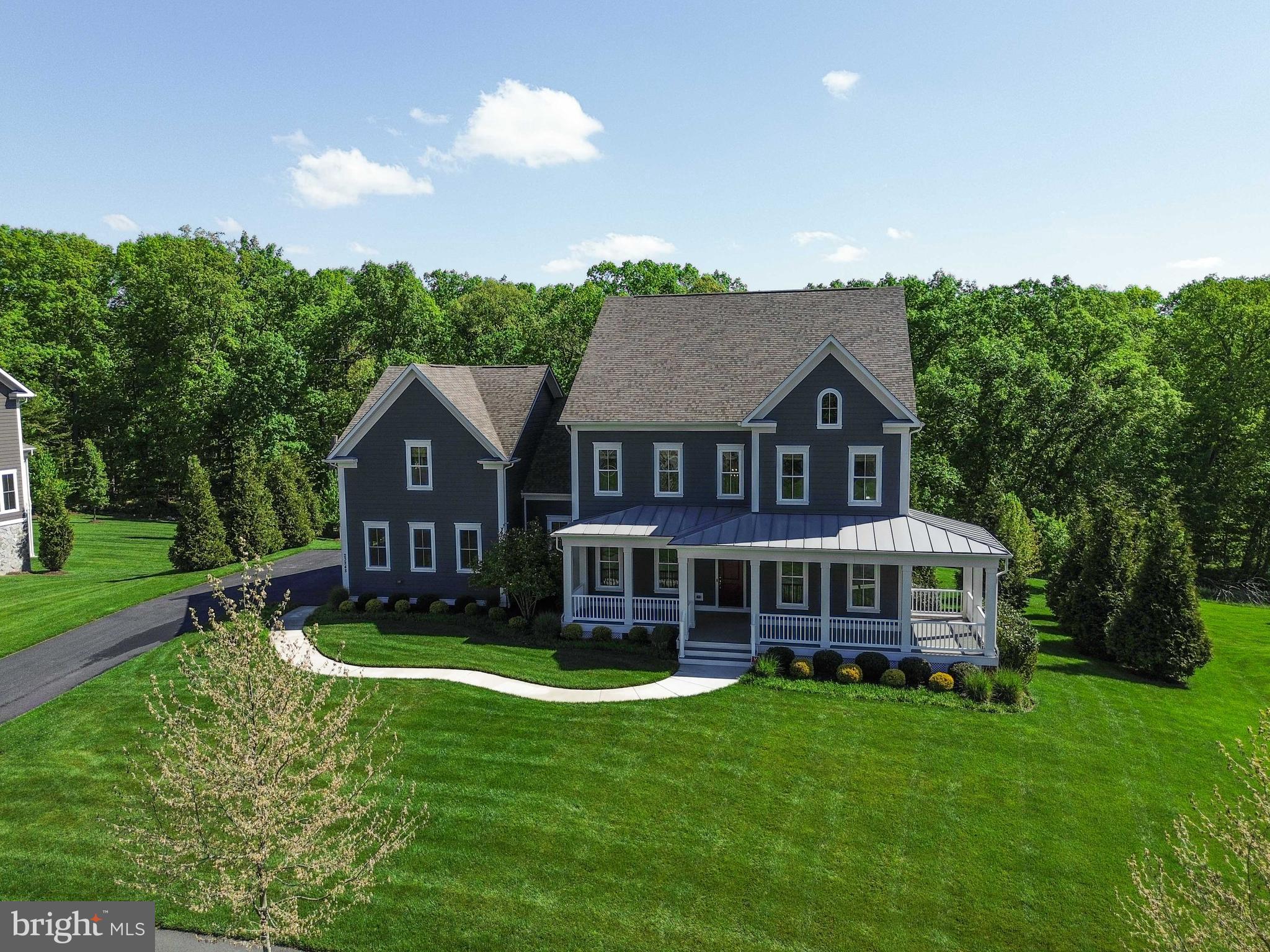 Welcome home! Come visit this move in ready gem, Willowsford and the luxurious Grant  community! Three gorgeous levels, boasting a blend of modern style and comfort. Featuring exceptional builder upgrades throughout. All this topped off with a premium lot backing to the conservatory woods!  Large wrap around porch, the home faces west, with a surreal setting for summer eves to come!   (Please see the 3D active tour link for a rich, inviting experience to this marvelous home.) From the front door enter to a two-story foyer and an array of classic moldings and accents, gorgeous pre-finished, wide plank hardwood floors, 10ft ceilings and neutral colors throughout. To the left is the formal dining room with chair rail, shadow box, crown moldings, designer fixtures. To the right, we have a convenient professional office or formal living space. Continuing on the main level is a captivating, large open floor plan great room and gourmet kitchen flooded with natural light from 12 windows and a walk out balcony door. The kitchen is exceptional with a 13ft center island and spectacular slab of Delicatus granite, stainless-steel, high-grade appliances, hood system & gas cooktop.  A newer french door refrigerator, and deep farmhouse sink. The great room boasts a huge footprint perfect for entertaining at 21’ x 23’ with coffered ceiling and gas fireplace for incredible ambiance. Adjacent to the Kitchn is a fabulous morning room addition, with a walk-out to rear, covered deck and overlook. An amazing feature for taking in the serene, wooded setting!  Enter from the garage to the large mudroom with built in cubbies and bench & back second staircase . The upper level hosts 9ft ceilings, generous 4 bedrooms, each with an en-suite bathroom and walk in closets. There is a convenient upstairs laundry room and multiple additional storage closets with built in shelving. The owner’s suite is to die for! With tray ceiling and adjacent large sitting area or additional office space, and  a fantastic personal walk out balcony overlooking the rear yard. Enjoy the morning coffee on this spectacular home feature! A large his & hers closets flank the incredible luxury bathroom with his & hers vanities, large walk-in shower and soaking tub, to complete this gorgeous owner’s suite. The basement level is a classic walk out with all the necessities! A full bedroom, full bathroom, and large entertainment space & muti-purpose room,  9ft ceilings and loads of natural light throughout. The lower level is also equipped with plumbing for full wet bar and pre-wired for surround sound for any entertainment media. Additionally there’s  abundant storage w/ utility systems, upgraded HVAC, whole house humidifier & whole house custom water filtration. walkout the basement to a massive flagstone patio flanked by professional landscaping of hydrangeas, ferns, hostas, tall grasses, cherry blossom trees, maple trees and crape myrtle trees  front and back irrigation and landscape lighting to enjoy this backyard oasis.  There is a covered outdoor kitchen space for grilling. So much to promote with this meticulously cared for home! The Grant Village of Willowsford, an award winning agri-hood community offering a luxury lifestyle and conveniences. The Willowsford Community boasts a working farm and farm stand with seasonal offerings, multiple pools, small lake for kayaking or canoeing, 13 mi. of walking trails, family campgrounds, dog park, playgrounds, community gym, available event venues, courts and social clubs all add to the vibrant modern living recipe. Truly a one-stop “has it all” community. 35 miles to Washington DC with fantastic commuter convenience to major thoroughfares, traffic free toll roads, metro stops and easy access to shopping, services,and social destinations within minutes to beautiful Virginia Wine Country. To cap it all off, the school system is in the highest ranks for the country!