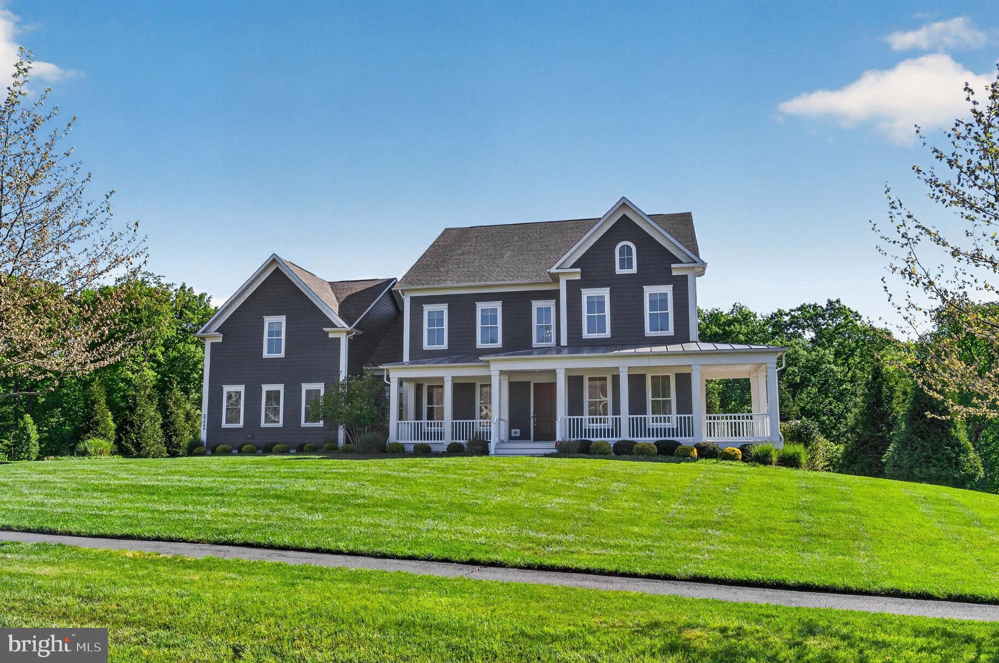 Welcome home! Come visit this move in ready gem, Willowsford and the luxurious Grant  community! Three gorgeous levels, boasting a blend of modern style and comfort. Featuring exceptional builder upgrades throughout. All this topped off with a premium lot backing to the conservatory woods!  Large wrap around porch, the home faces west, with a surreal setting for summer eves to come!   (Please see the 3D active tour link for a rich, inviting experience to this marvelous home.) From the front door enter to a two-story foyer and an array of classic moldings and accents, gorgeous pre-finished, wide plank hardwood floors, 10ft ceilings and neutral colors throughout. To the left is the formal dining room with chair rail, shadow box, crown moldings, designer fixtures. To the right, we have a convenient professional office or formal living space. Continuing on the main level is a captivating, large open floor plan great room and gourmet kitchen flooded with natural light from 12 windows and a walk out balcony door. The kitchen is exceptional with a 13ft center island and spectacular slab of Delicatus granite, stainless-steel, high-grade appliances, hood system & gas cooktop.  A newer french door refrigerator, and deep farmhouse sink. The great room boasts a huge footprint perfect for entertaining at 21’ x 23’ with coffered ceiling and gas fireplace for incredible ambiance. Adjacent to the Kitchn is a fabulous morning room addition, with a walk-out to rear, covered deck and overlook. An amazing feature for taking in the serene, wooded setting!  Enter from the garage to the large mudroom with built in cubbies and bench & back second staircase . The upper level hosts 9ft ceilings, generous 4 bedrooms, each with an en-suite bathroom and walk in closets. There is a convenient upstairs laundry room and multiple additional storage closets with built in shelving. The owner’s suite is to die for! With tray ceiling and adjacent large sitting area or additional office space, and  a fantastic personal walk out balcony overlooking the rear yard. Enjoy the morning coffee on this spectacular home feature! A large his & hers closets flank the incredible luxury bathroom with his & hers vanities, large walk-in shower and soaking tub, to complete this gorgeous owner’s suite. The basement level is a classic walk out with all the necessities! A full bedroom, full bathroom, and large entertainment space & muti-purpose room,  9ft ceilings and loads of natural light throughout. The lower level is also equipped with plumbing for full wet bar and pre-wired for surround sound for any entertainment media. Additionally there’s  abundant storage w/ utility systems, upgraded HVAC, whole house humidifier & whole house custom water filtration. walkout the basement to a massive flagstone patio flanked by professional landscaping of hydrangeas, ferns, hostas, tall grasses, cherry blossom trees, maple trees and crape myrtle trees  front and back irrigation and landscape lighting to enjoy this backyard oasis.  There is a covered outdoor kitchen space for grilling. So much to promote with this meticulously cared for home! The Grant Village of Willowsford, an award winning agri-hood community offering a luxury lifestyle and conveniences. The Willowsford Community boasts a working farm and farm stand with seasonal offerings, multiple pools, small lake for kayaking or canoeing, 13 mi. of walking trails, family campgrounds, dog park, playgrounds, community gym, available event venues, courts and social clubs all add to the vibrant modern living recipe. Truly a one-stop “has it all” community. 35 miles to Washington DC with fantastic commuter convenience to major thoroughfares, traffic free toll roads, metro stops and easy access to shopping, services,and social destinations within minutes to beautiful Virginia Wine Country. To cap it all off, the school system is in the highest ranks for the country!