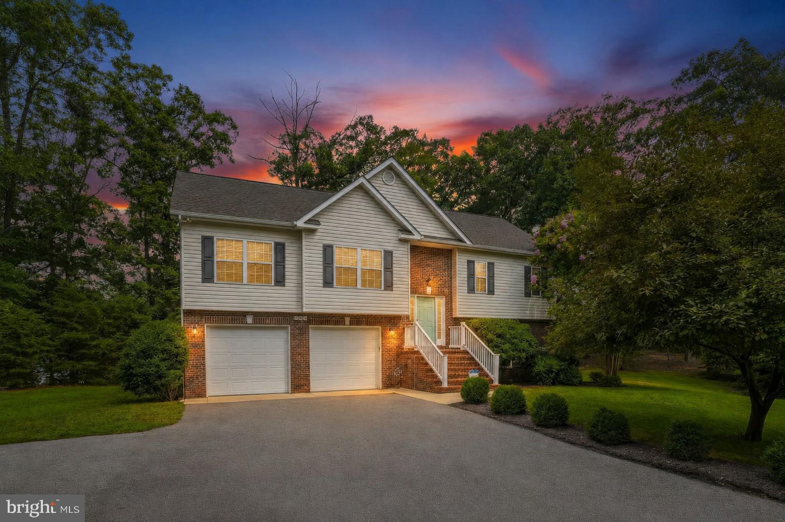 This 4-bedroom, 3-bath home in the desirable Town Creek community of St. Mary's County offers over 2,300 total square feet on nearly half an acre. This one-owner home features hardwood floors throughout the main level, a gas fireplace with a stone accent wall, and a renovated kitchen with quartz-style counters, a subway-tile backsplash, and additional cabinet space.

The main level offers 3 bedrooms, including a primary suite with a large walk-in closet, a separate walk-in shower, and a soaking tub with a double-sink vanity. The hall bathroom features a new vanity and mirror.
In the fully finished lower level, the 4th bedroom, a separate large rec room, a full bath, ideal for guests, a home office, or extra living space. Just steps from the walkout to the patio, a utility sink offers a convenient spot to rinse off tools and grilling gear before a cookout.

Oversized 2-car garage with inside access and a garage door opener. Outside, enjoy the deck and a two-level stone patio with a fire pit area overlooking the nearly half-acre wooded lot, plus a backyard zip line for added outdoor fun, ideal for entertaining. HVAC and water heater are both approximately 3 years old.
No HOA! Residents of Town Creek enjoy access to a community pool available with membership, plus a tennis court and playground. Centrally located in Lexington Park, close to shopping, dining, and NAS Pax River, this move-in-ready split foyer won't last long.