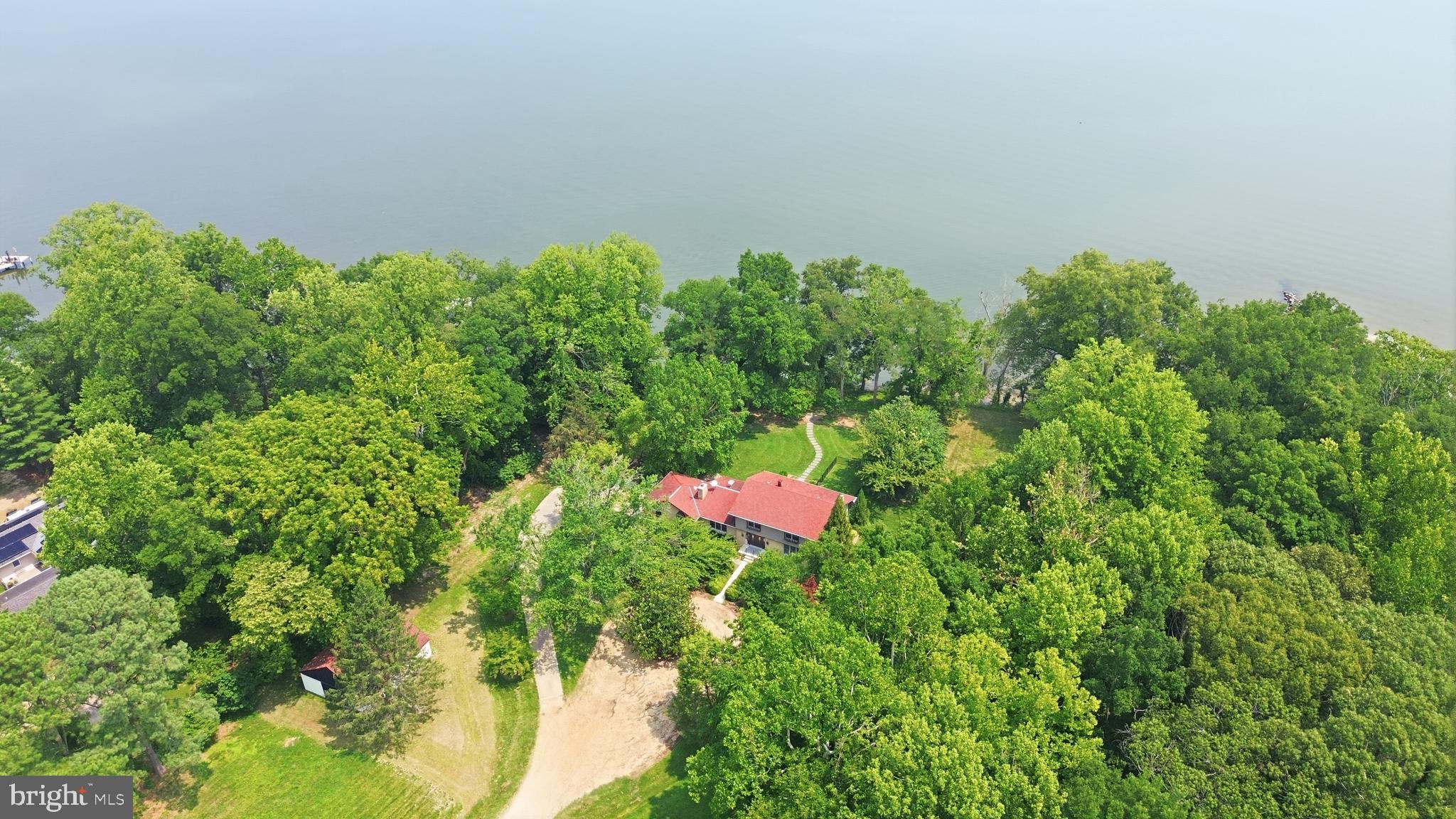 Nestled along the shores of the Patuxent River is this very private, custom-built, all brick home with beautiful hardwood floors throughout, modern kitchen and baths situated on 5 sprawling acres. Riprapped shoreline, professionally landscaped yard, 4 stall horse barn, dog run and more. Enjoy nature's beauty on the water; conveniently located for a D.C. commute. A great get-away for enjoying peace and tranquility in the Country.