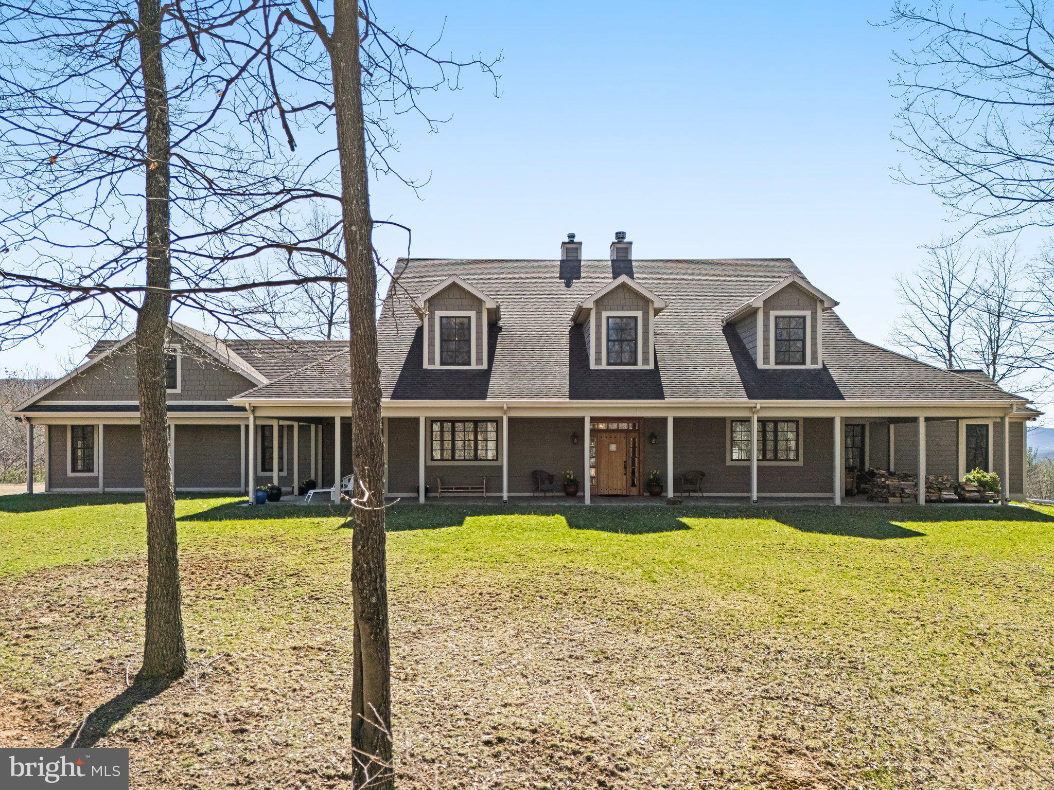 Nestled atop the scenic Polish Mountain, this meticulously maintained 300± acres retreat, just 2 hours from DC/Baltimore, offers unmatched privacy, sweeping vistas, and grand sunset views. Take in the serene landscape from the wrap-around front porch or the expansive back deck that spans the entire rear of the home, providing an idyllic setting to relax and unwind.

Upon entering, you are greeted by an open, airy living space with rich wood floors, high ceilings, and oversized double-pane Pella windows that flood the rooms with natural light. This high efficiency home features SIP panel construction and geothermal heat. 

The kitchen, with sleek countertops and a gas stove, flows seamlessly into the family room and dining area, highlighted by a centrally located wood-burning energy efficient fireplace with brick surround and marble-tile hearth.

A gracious living room, just around the corner, boasts the home's second energy efficient fireplace and provides an elegant space for entertaining guests or enjoying family gatherings.

The first floor is home to two well-appointed bedrooms, each with walk-in closets and private en suite bathrooms — one offering a classic clawfoot tub, the other a spacious standing shower. A convenient first-floor powder room, laundry room, and mudroom next to the attached two-car garage complete this thoughtfully designed main level. An additional two-car garage is accessible from the unfinished basement.

Upstairs, you will find three additional bedrooms, all with walk-in closets. One bedroom enjoys the luxury of an en suite bathroom, while the others share a well-conceived Jack-and-Jill bathroom, ensuring comfort and privacy for all. Large, open rooms complete the second floor, offering a blank slate ready to be tailored to your lifestyle. Whether envisioned as an additional living area, studio, or home office, the possibilities are endless in this versatile upper level.

Outside, a 30’x80’ Morton building and second large workshop offer plenty of space for cars, equipment, and storage while underground power lines offer unobstructed views. The 303± acres property is perfect for hunting, four wheeling, and more. Experience the natural beauty and charm of the region with attractions such as Rocky Gap State Park, the Western Maryland Scenic Railroad, Deep Creek Lake, the Great Allegheny Passage. Enjoy upscale amenities at Rocky Gap Casino, Resort & Golf, all surrounded by a wealth of outdoor activities perfect for all ages

This exquisite property effortlessly blends refined living with the serenity of nature, offering a peaceful retreat that’s both luxurious and family-friendly — an ideal haven for creating lasting memories in one of Western Maryland’s most picturesque settings.