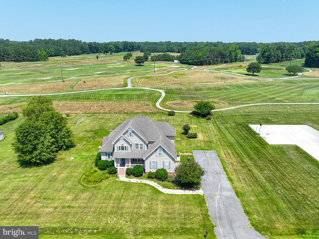 Wow! This custom-built 5-bedroom, 3-full-bath home offers the perfect combination of quality craftsmanship, space, and privacy on 3.45 beautifully maintained acres, just minutes from Ocean Pines, Berlin, and Ocean City. Enjoy peaceful golf course views from your backyard overlooking Ocean Resorts Golf Club while experiencing the tranquility of country living with the convenience of nearby beaches, shopping, dining, and entertainment.

Designed for both everyday living and entertaining, the open-concept floor plan features a custom kitchen with hardwood floors that flows seamlessly into the spacious living area. Enjoy casual meals in the eat-in kitchen or host family gatherings in the formal dining room, which also makes an ideal home office or flex space.

The first-floor primary suite offers a relaxing retreat with a spacious en-suite bath and walk-in closet. Four additional generously sized bedrooms, three full baths, oversized closets, and abundant storage provide room for family, guests, hobbies, or multigenerational living.

Step outside to enjoy the expansive deck overlooking the above-ground pool, where you can relax, entertain, or simply take in the scenic golf course views. A blacktop driveway provides plenty of parking and adds to the home's curb appeal. Sold mostly furnished, this move-in-ready home offers exceptional value, combining custom construction, acreage, privacy, and an unbeatable location close to everything the Eastern Shore has to offer.
