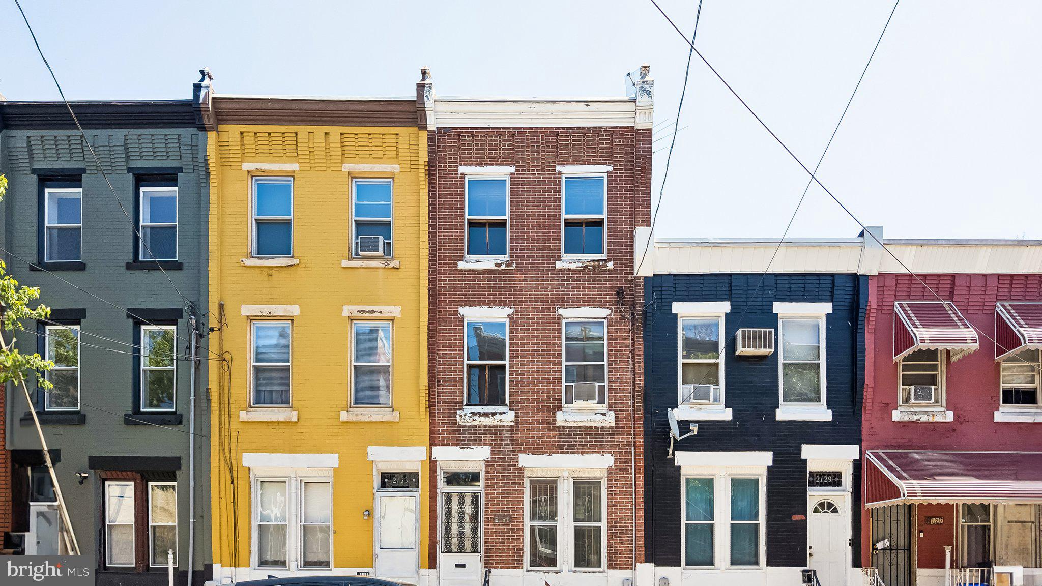 Consider exploring this huge three story interior row home in the 19121 section of Philadelphia. This classic brick straight thru home offers quite square footage of nearly 1,400-1,500 square feet with its dramatically high ceilings, a dual living room and dining room combination layout, and a kitchen large enough for adding your own customization and room for a table for eat-in. The kitchen has recently been updated with newer countertops and cabinetry. Right from the kitchen you have access to an enclosed sun room with direct access to the private fenced in rear yard. You will discover three well-sized bedrooms upstairs on the second floor, including the front facing larger bedroom, which does have jack and Jill access to the middle bedroom. One full bathroom, which has been updated with newer flooring, is located on this second floor. Continue upstairs to the third floor to discover an additional two bedrooms! The unfinished basement is very large and runs a good length of the house. Upgrades include a newer hot water tank, newer heating system, and an updated electrical panel. This property is surrounded by renovated properties, adding instant value to the immediate neighborhood. A stone throw away is neighborhoods Brewerytown, Art Museum District, as well as a short commute to all the sights and sounds of Center City! Consider adding seeing 2131 N 28th Street to your list of properties today.