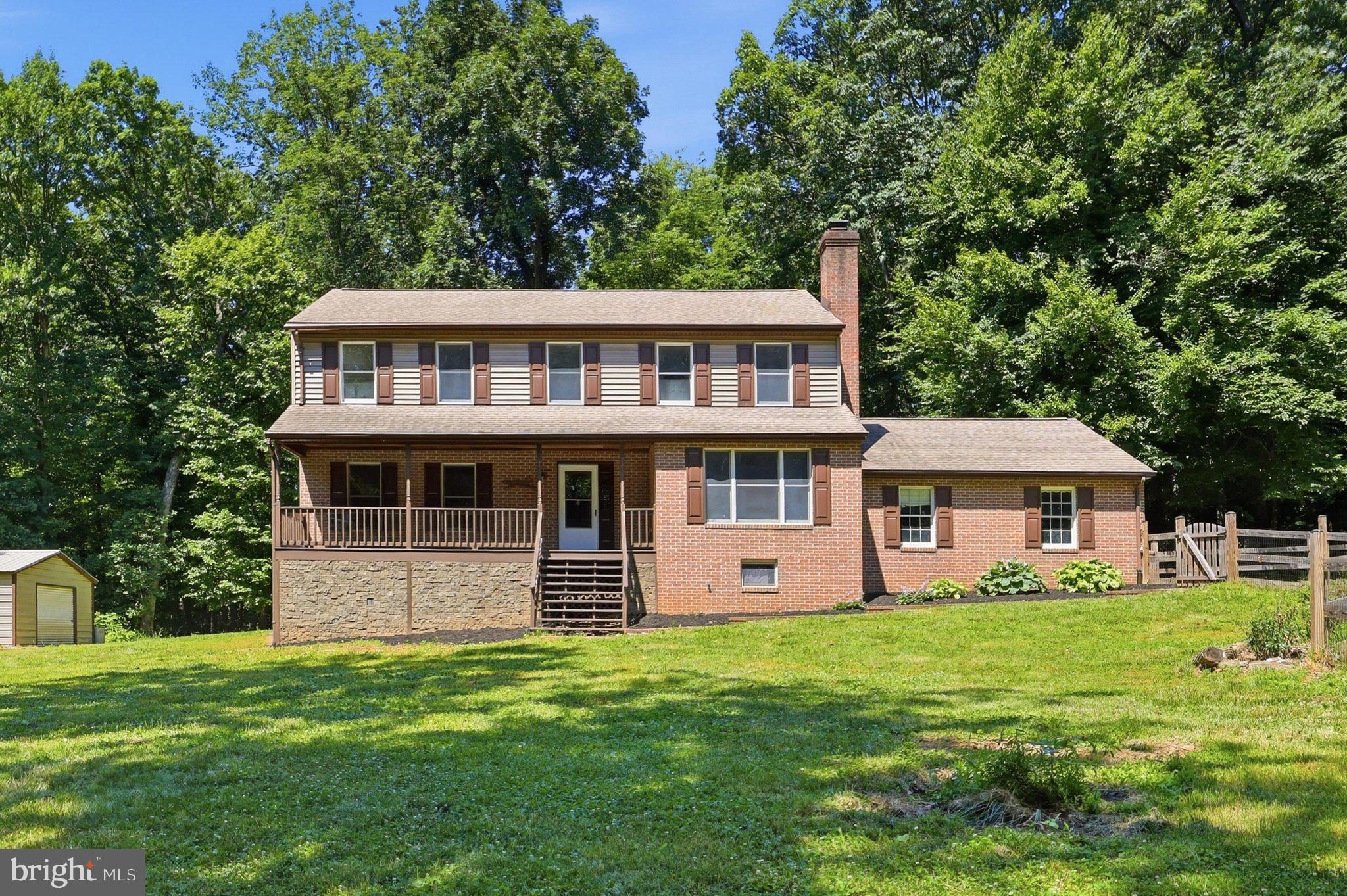 Welcome to this exceptional Colonial-style home situated on 5 private, level acres with no HOA and no restrictive covenants, offering the perfect blend of comfort, functionality, and freedom. Built in 1991 and boasting over 3,244 square feet of finished living space, this beautifully maintained 4-bedroom, 2.5-bath residence is ready for its next owner. Step inside to discover fresh paint throughout, gleaming hardwood floors, and brand-new carpeting. The heart of the home is the gourmet kitchen featuring corian countertops, tile backsplash, oak cabinetry, newer appliances, and a spacious eat-in dining area perfect for everyday living and entertaining. The open-concept design flows seamlessly into the expansive family room, highlighted by a striking brick fireplace that creates a warm and inviting atmosphere. The main level also offers a formal dining room, convenient laundry area, and abundant natural light throughout. Upstairs, the spacious owner's suite provides a private retreat complete with a walk-in closet and en-suite bath with tile finishes. Three additional generously sized bedrooms offer flexibility for family, guests, or home office needs. The fully finished walk-out basement & rec. room expands the living space and provides endless possibilities for recreation, fitness, entertainment, bonus room or multi-generational living, while a separate storage room adds valuable functionality. Outside, enjoy peaceful country living from the large covered front porch overlooking a private wooded setting. Recent improvements include fresh interior paint, new carpeting, new rear steps, gutter guards, newer appliances, and a roof approximately 10 years old &  BRAND NEW HVAC system- The oversized 2-car garage and large pole building provide abundant storage and workspace for vehicles, equipment, hobbies, or a home-based business. Serviced by private well and septic systems, this property offers independence from public water and sewer bills while embracing the benefits of rural living. Conveniently located with easy access to commuter routes and close proximity to the Amtrak train station, this remarkable property combines privacy, acreage, and modern convenience in one exceptional offering. A rare opportunity to own a spacious home on 5 unrestricted acres where comfort, privacy, and endless possibilities await.  This is a MUST SEE !!!