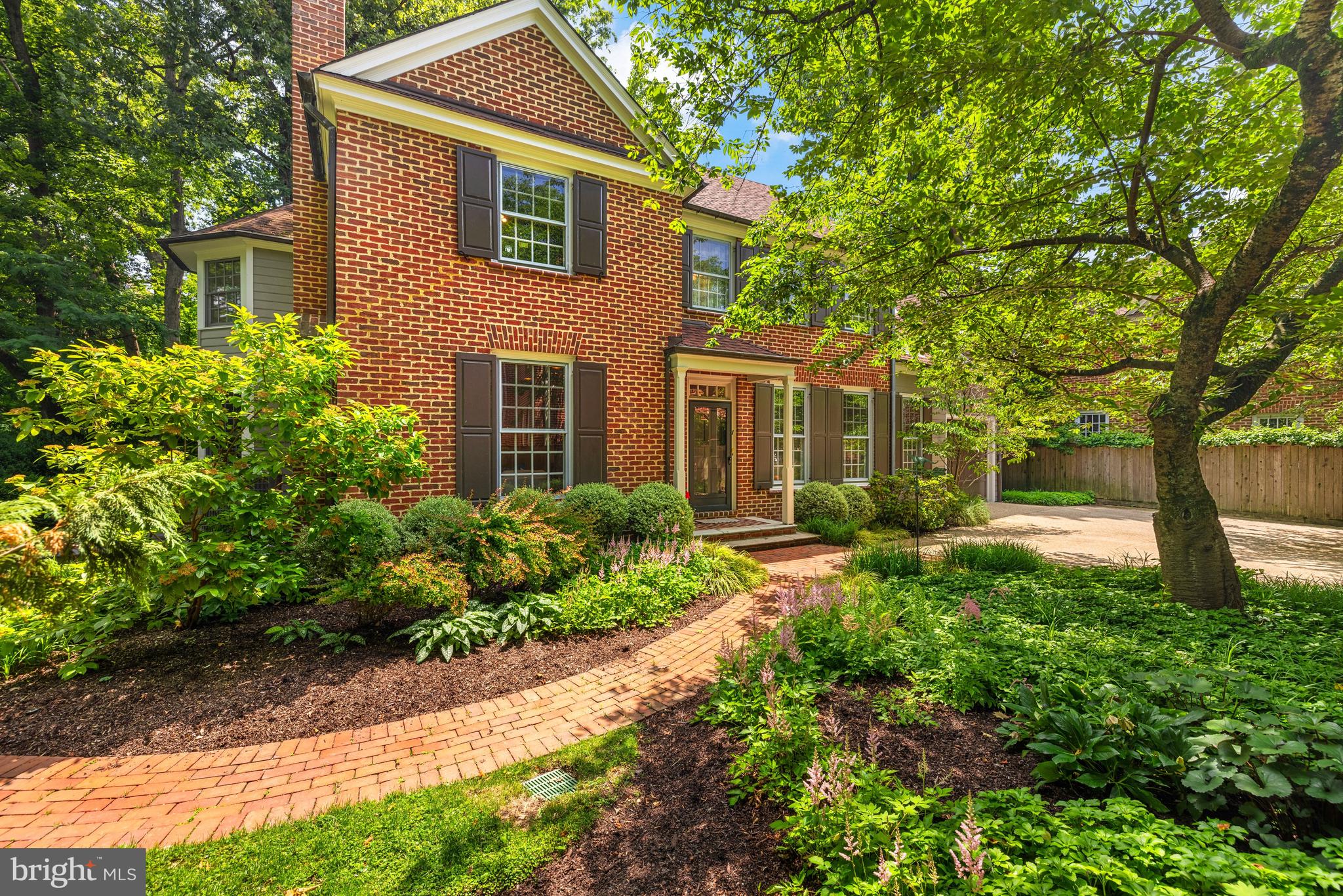 Gracious brick Colonial hidden-in-plain-sight on private cul-de-sac surrounded by serene parkland in prime Cleveland Park location! Expansive, airy floor plan of over 5,000 SF ideal for modern living features large rooms and tranquil leafy views throughout. Main level with 9' ceilings features foyer with coat closet and powder room; formal living room with gas fireplace; elegant dining room; SPECTACULAR OPEN KITCHEN/FAMILY ROOM with breakfast area, wood-burning fireplace, office area, laundry/mud room, and access to the home's attached garage. Upstairs is a sizable primary suite with vaulted ceilings, fireplace, many built-ins, and en suite bath/dressing room. Three additional generously-proportioned bedrooms with great closets, and two additional full bathrooms complete the level. The lower level features a bedroom, full bathroom, large family/rec room with adjoining bonus room and porch, and plentiful storage space! Rear deck with incredible privacy and woodland views, lovely flat surrounding greenspace, easy parking in attached garage and driveway spaces. All this in a DREAM LOCATION! Walk to everything - multiple schools, transit, as well as countless shops, restaurants, and amenities - Cactus Cantina, La Piquette, Barcelona, Raku, Starbucks, Jetties, Giant, Wegmans, Equinox, Tatte, lots more!