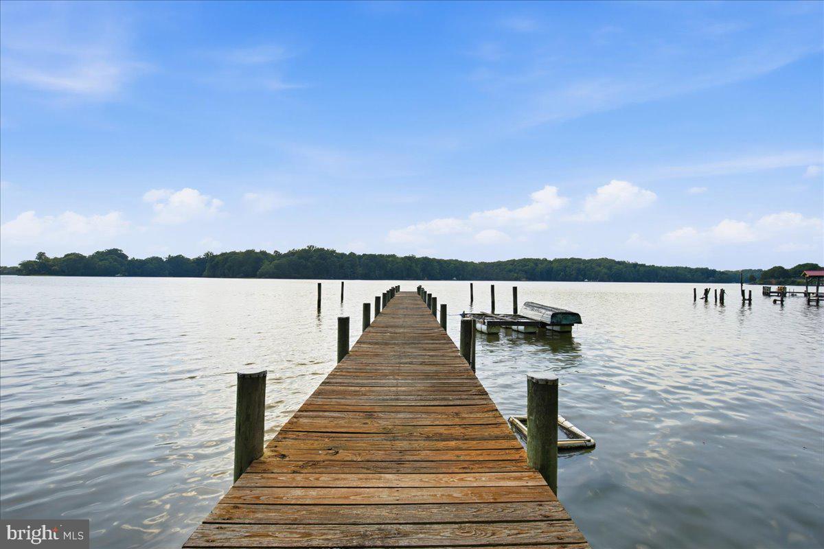 Welcome to the kind of property that rarely comes available and can never truly be replicated.
Nestled along the shores of historic Battle Creek, this beloved waterfront retreat has been cherished by the same family for generations. More than a home, it is a place filled with stories, traditions, and memories made on the water.
Set on nearly an acre of private waterfront land, the property features two cabins and three separate sleeping areas, creating a unique compound perfect for family gatherings, weekend escapes, fishing trips, and unforgettable summers on the creek. A deep-water pier with multiple slips provides easy access for boating, crabbing, kayaking, and waterfront adventures.
The cabins have been thoughtfully updated with fresh paint, newer roofing, and luxury vinyl plank flooring while maintaining the relaxed charm that makes this property so special. Here, you'll spend your days exploring the creek, watching wildlife, enjoying the privacy of your wooded surroundings, and ending each evening with breathtaking sunsets and star-filled skies.
Perfect as a weekend retreat, vacation rental, or personal waterfront sanctuary, this is an opportunity to own a truly unique piece of Southern Maryland waterfront where the focus isn't on square footage, but on the lifestyle that comes with it.
