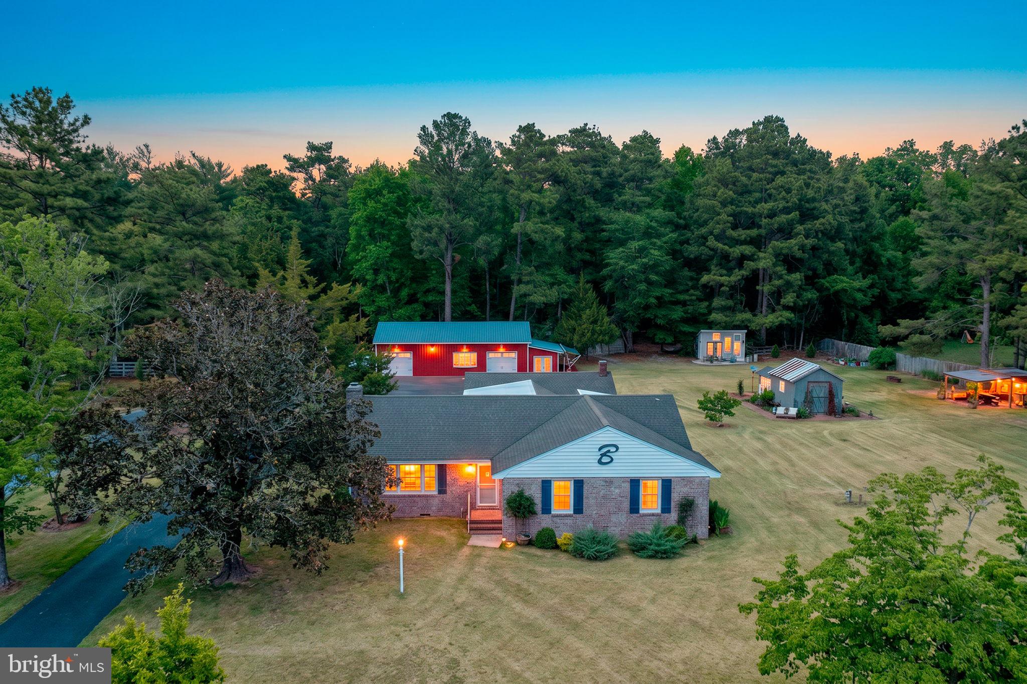 Welcome to 132 Deep Shore Rd—an inviting homestead set on more than 3 acres of beautifully maintained gardens, thoughtfully designed outdoor spaces, and versatile outbuildings. From greenhouse and herb beds to a dedicated drying room and casual nooks for lounging, every corner invites you to savor the seasons.

Inside, this spacious home offers over 2,700 sq ft with 4 bedrooms and 2.5 baths. An open den with brick tile flooring flows to a charming side porch with a swing—perfect for evening breezes and views of the yard. Warm hardwood floors carry through the dining room and into the kitchen and family room, creating an easy, open flow ideal for everyday living and entertaining. The family room centers around a gas fireplace with a handcrafted black walnut mantel, while a granite-topped built-in serves as a convenient entertainment hub.

The chef’s kitchen features quartz countertops, double ovens, a gas cooktop with hood, and generous storage. Three well-appointed bedrooms sit on one side of the home—one showcasing a custom bedframe with built-in storage, another featuring a clever Murphy bed and its own half bath. The private primary suite is tucked on the opposite side and includes a walk-in closet with custom built-ins and an en suite bath.

Outdoors, the property is a hobbyist’s dream. You’ll find multiple outbuildings for storage and projects, along with 5 frost-proof yard spigots plus 2 additional spigots on the home for effortless garden care. A 50' x 30' garage is paired with an attached 10' x 30' sunroom. The main shop includes a large storage area, parking, a substantial wood shop, and an additional garage bay equipped with a 7,000 lb. lift. Enjoy all the comforts of home in the shop and sunroom as they offer Heat and Air. Electric as well in all other outbuildings as well. 

Location is the finishing touch: directly across from the front entrance to Martinek State Park, offering camping, trails, a playground, picnic areas, a public boat ramp, and fishing on Watts Creek with direct access to the Choptank River. Here, you’re surrounded by nature, recreation, and room to grow—an exceptional blend of comfort, craft, and country living at 132 Deep Shore Rd.