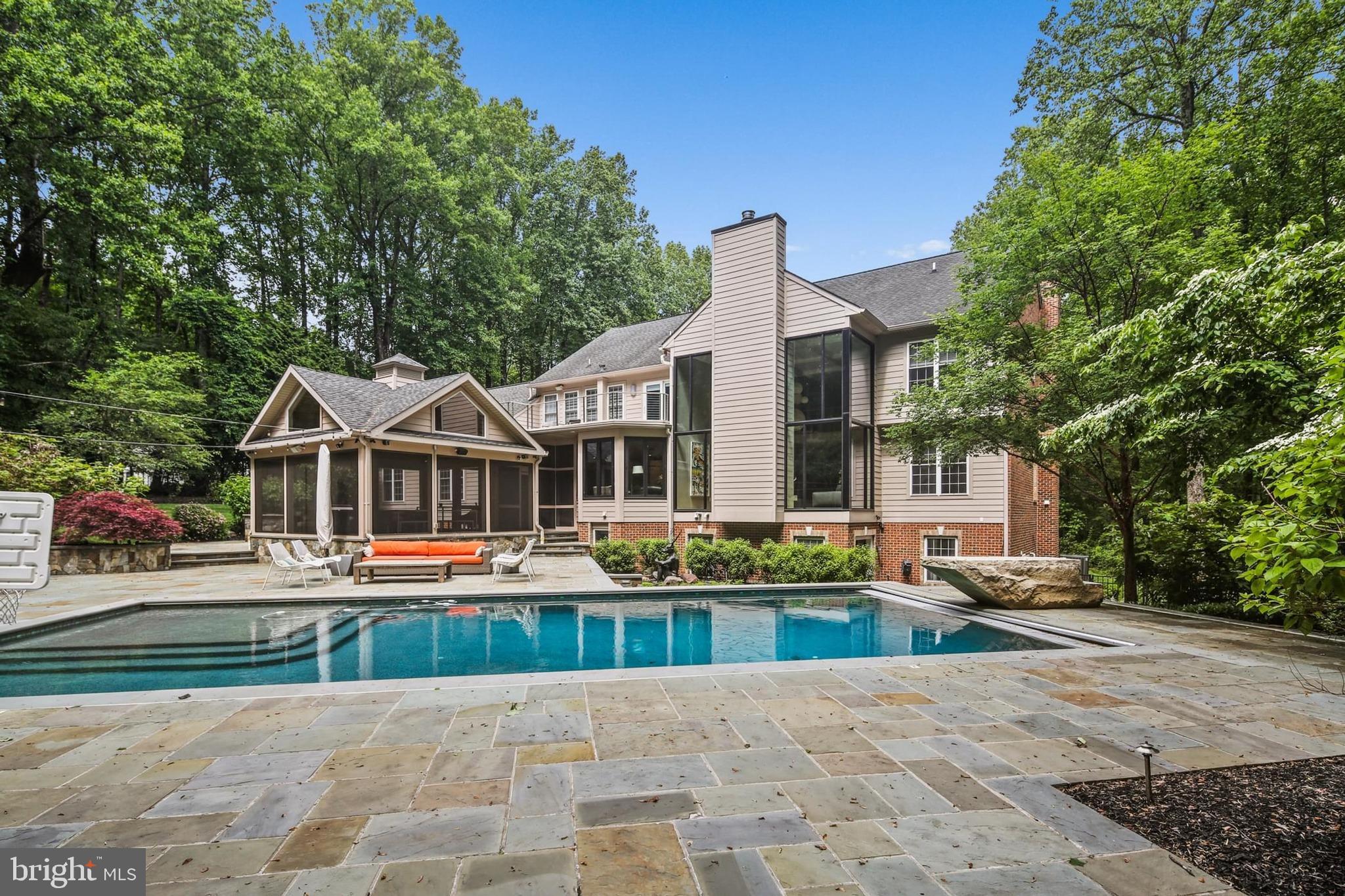 If you are looking for custom, sleek, and truly move-in ready, this one-of-a-kind Clarksville home delivers at every turn. Situated on 3.25 private acres and completely redesigned by KUBE Architecture with no expense spared, this contemporary masterpiece offers 6 bedrooms, 4 full and 2 half baths, and a 3-car garage.  The striking modern design sets this home apart—there is simply nothing like it in the area. White oak hardwood, floating staircase, floor to ceiling windows, heated bathroom floors - all design features stand out. At the heart of the home is a chef’s kitchen featuring top-of-the-line appliances, custom cabinetry, and an open layout perfect for everyday living and entertaining. Step outside and experience a true resort lifestyle with a screened porch, pool with a stone diving board, outdoor kitchen, and a professional putting green - plus a fully equipped in-home gym. Perfectly located with ultimate privacy yet close to everything in DC and Baltimore, including top-rated schools, this home offers a rare combination of luxury, lifestyle, and location. A spectacular alternative to new construction without the wait.