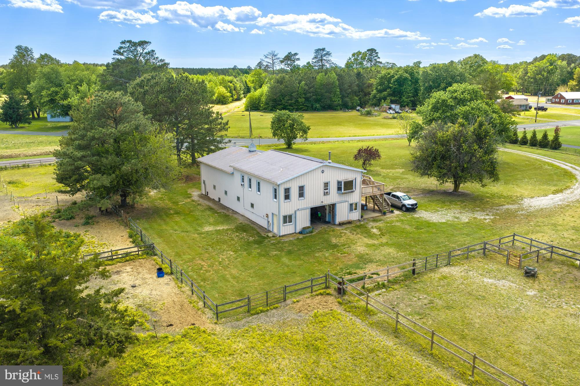 Horse farm opportunity in a peaceful country setting on 8.5± acres. This well-equipped equestrian property features a 2-story 36x72 Morton barn with 8 stalls, wash stall, spacious hay loft, and a second-floor apartment offering 2 bedrooms, kitchen, living room, and den—ideal for trainers, guests, or farm staff. The impressive well lit 80x200 indoor riding arena with dust elimination treated footing, and multiple access doors provides the perfect setup for riding, training, instruction, or small horse shows year-round. The property is fully fenced with both wood and electric wire fencing.
-Spacious 1,296 SF 2-bedroom apartment situated above the main barn, which features 8 stalls, 2 tack rooms, a half bath, and dedicated laundry area.
-Impressive 16,000 SF pole building equipped with 7 additional stalls, multiple water spigots, and wired run-in areas designed for efficient horse care and operations.
-Also available is a large outdoor riding ring and several turn out paddocks of different sizes.
-The property has had a very successful boarding operation with their 15 stalls and run in indoor access
-The location offers the tranquility of country life while conveniently located only minutes away from Rt 13 and the bypass
-Original builder intended on building an additional ranch style hoe on the acreage fronting Meadowbridge Rd. Soil types seem conducive to passing a percolation test.