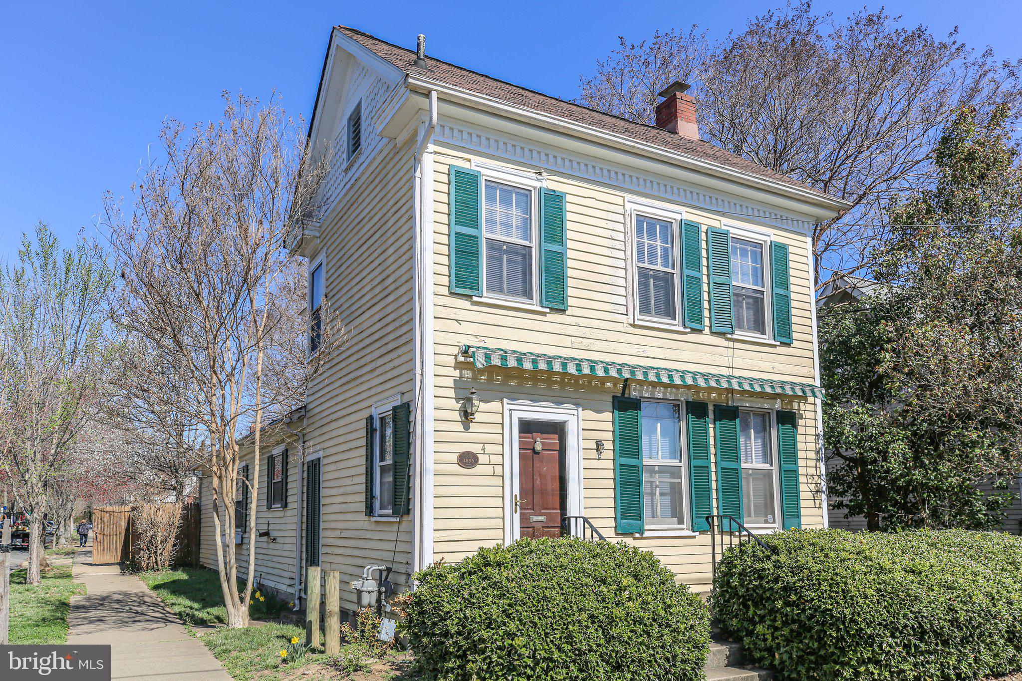 Fabulous 1896 Colonial in downtown Fredericksburg with a one level addition added in the 70's and a renovation  in 2010 that created a large main level Primary Bedroom, walk in closet and full bath w/stacker washer and dryer....all allowing for complete one level living.  Beautiful original hardwood floors throughout most of the home and stainless appliances in the kitchen.
The upper level includes a second full bathroom and two rooms that could be used as one or two bedrooms or a study/office/flex space.  Interior space is complete with an unfinished basement on the original 1896 portion of the home.
Situated on a corner lot, the exterior is complete with a privacy fenced rear and side yard, extensive brick patio/pavers and a nice 10x8 shed.  While there is currently no off-street parking, an existing curb cut on the Prince Edward Street side could allow for future off-street parking.
Don't miss this opportunity to buy downtown and create some "sweat equity" on this fantastic home!
