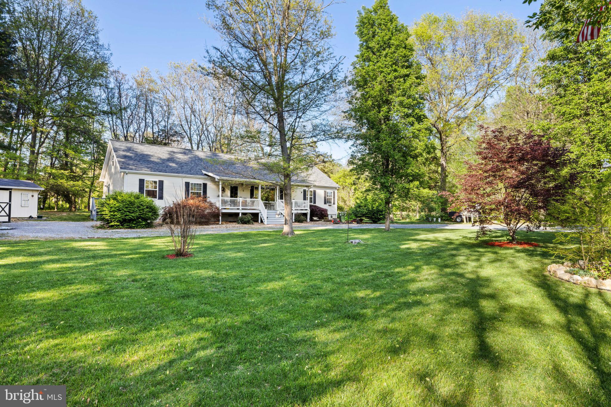 Situated on a serene 1-acre wooded lot, this charming 3 bed, 2 bath ranch home offers nearly 2,000 square feet of cozy living. Inside, you'll find hardwood and tile flooring along with warm pine tongue-and-groove ceilings. The open-concept main living area features a spacious living room with a beautiful picture window, flowing into the dining area and kitchen, which boasts wood cabinetry, an island with built in fireplace, and stainless steel appliances. The primary suite includes a large master bath with a double vanity, jacuzzi tub, and walk-in shower. Two additional bedrooms and a full bath provide comfort for family or guests. An unfinished upstairs area offers great potential for a gym, office, or extra bedrooms. Enjoy the large covered front porch and multiple outdoor sheds with electricity for hobbies or storage. Conveniently located between Staunton and Harrisonburg, this home is a must-see!