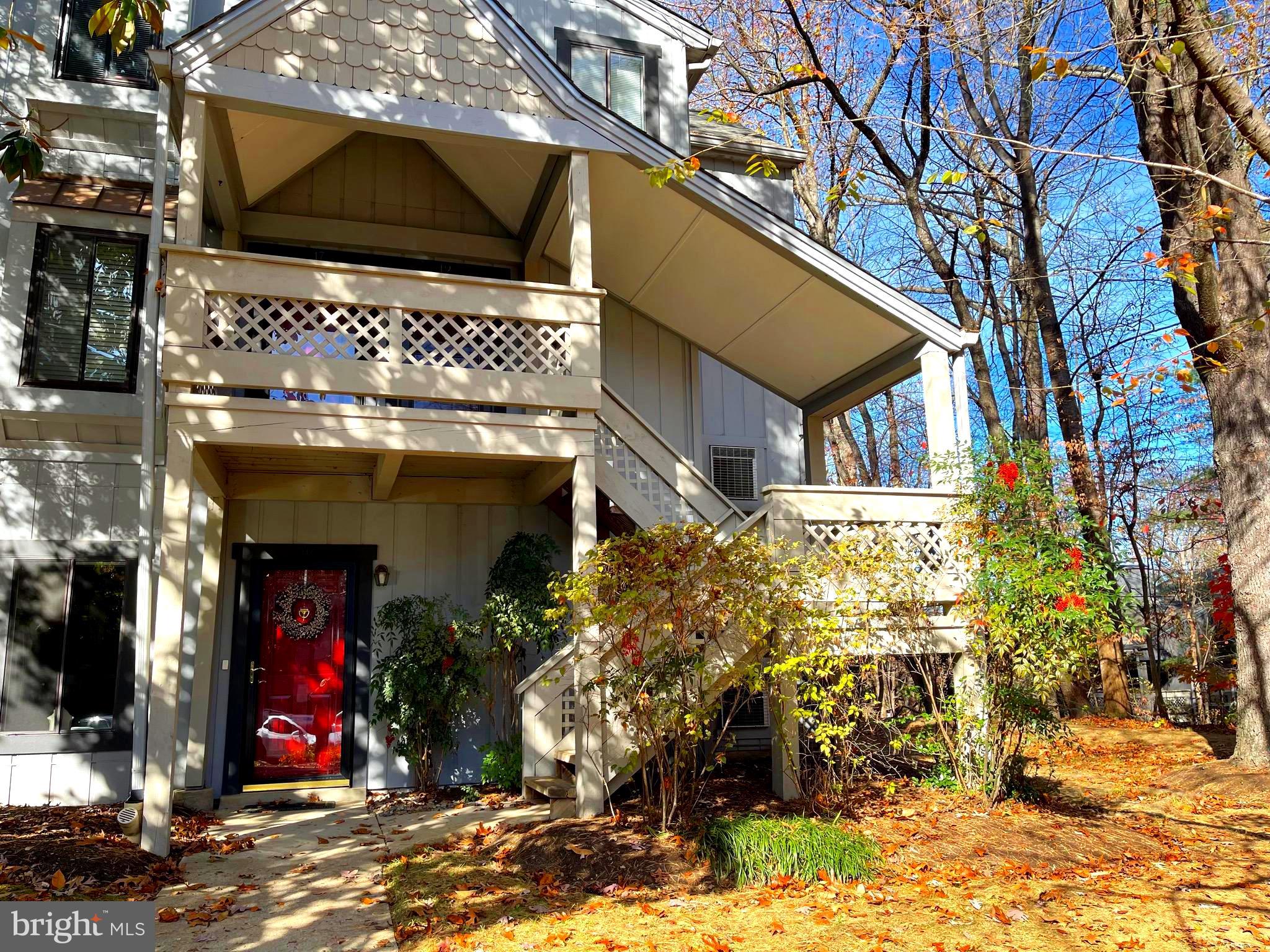 This spacious, updated two-level one-bedroom home (1,057 sq ft) is one of the largest one-bedroom units available and a must-see! Nestled among the trees, it features a covered entrance opening to a large tile-floored foyer. The upper level includes a generous kitchen, a huge bedroom with a walk-in closet, a large bathroom, and an open living/dining area with vaulted ceilings and a cozy wood-burning fireplace and a beautiful sunroom, with its wall of windows leads to a covered deck—perfect for morning coffee and peaceful nature views. The condo also has an in-unit washer and dryer. The pet-friendly community offers a fantastic pool, well-maintained grounds, and plenty of available parking. Conveniently close to I-270 / 355, shopping, Costco, and schools,  this home offers both accessibility and a serene, tucked-away feel.
