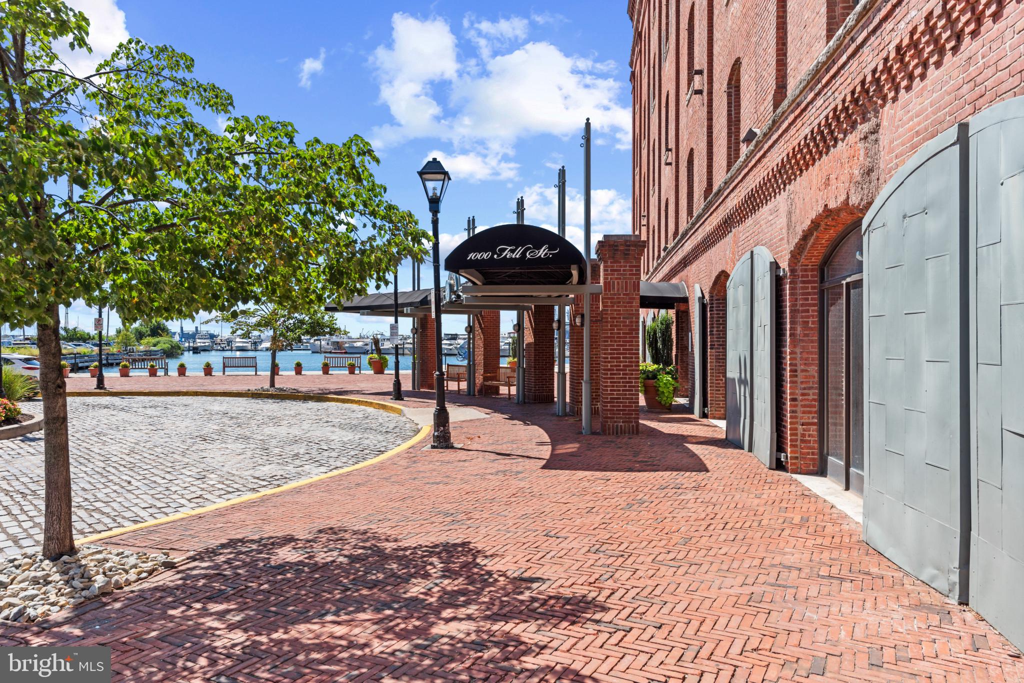 Nestled within the prestigious Henderson's Wharf in historic Fells Point on a cobblestone street, this unique one-bedroom, one-bathroom condo offers an open-concept living/dining area with floor to ceiling french door windows with juliett balcony overlooking the private courtyard, providing fresh air and beautiful natural light. The updated galley kitchen features white shaker cabinetry, neutral quartz counters, a mosaic tile backsplash, and stainless steel appliances. The lower-level owner's suite includes a large bedroom with French door windows, a Juliette balcony, and a fabulous courtyard view. The updated primary bathroom features tile flooring, a double sink vanity with a marble counter, and an in-unit laundry.
Park in the attached garage with one deeded parking space. Owners just installed a new HVAC system with a transferable warranty.
Living in Henderson's Wharf means immersing yourself in the vibrant culture and history of Fells Point. This iconic neighborhood is renowned for its cobblestone streets, charming boutiques, and an array of dining options, from cozy cafes to upscale restaurants. The lively waterfront offers endless opportunities for recreation, including sailing, kayaking, and scenic walks along the promenade. Enjoy the convenience of being just a short walk from the bustling Inner Harbor, with its world-class attractions, shopping, and entertainment. Commuters will appreciate easy access to major highways and public transportation, making exploring all Baltimore offers effortless.

Community amenities at Henderson's Wharf include 24-hour security, a fitness center, a private courtyard for a serene retreat, and one assigned parking space in the attached secured garage. This exceptional condo in Henderson's Wharf is more than just a home; it's a lifestyle. Don't miss your chance to experience the perfect blend of luxury, history, and modern living in one of Baltimore's most sought-after neighborhoods. Schedule your private tour today and envision the unparalleled lifestyle in Fells Point!
