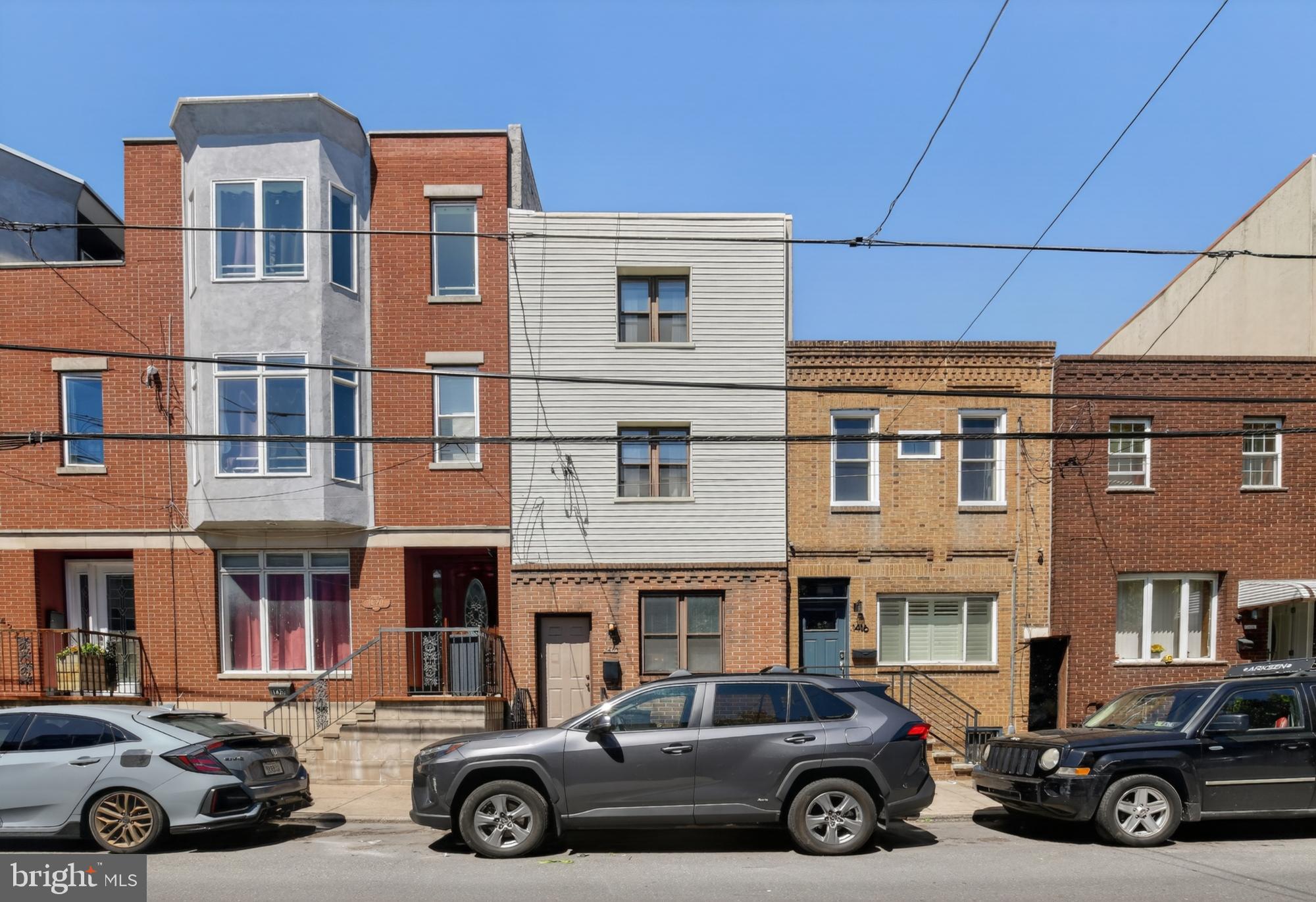 Located in highly desirable 19147, 1418 S 8th Street presents an opportunity for both seasoned investors and aspiring owner-occupants. This well-positioned duplex is fully occupied for someone looking for a great investment or the flexibility of a primary residence with the financial benefits of an income-generating asset, all within one of Philadelphia’s most sought-after neighborhoods. The first floor unit is a 1 bedroom/1 bathroom. This unit welcomes you into an open layout. The kitchen features stainless steel appliances, textured laminate flooring, a window in the front that lets in lots of natural light, and a bar for extra seating or prep space. The dining/living area is connected, and offers clean wall-to-wall carpeting, track lighting, and a closet with stacked washer and dryer. The bathroom and bedroom are in the rear of the unit, and are both roomy with plenty of storage. The second unit is bi-level with 2 bedrooms and 1 bathroom. There are espresso hardwood floors, bright natural light, a private deck, great storage space, central a/c, laundry in-unit, and modern finishes throughout. The first level features spacious living and dining space, a generous kitchen, and laundry. At the rear is a large private balcony. Upstairs, there are two opposite-end bedrooms with a bathroom in between. Want to explore? You can easily walk to the historic Italian Market for diverse culinary delights and fresh ingredients, or explore the unique shops and lively atmosphere of nearby South Street and Philadelphia's Magic Gardens. The location offers excellent access to major historic landmarks like the Liberty Bell and Independence Hall, placing you near the heart of Old City. For recreation, you are close to green spaces like Washington Square and seasonal waterfront fun at Penn's Landing. Schedule a tour before it's gone!
