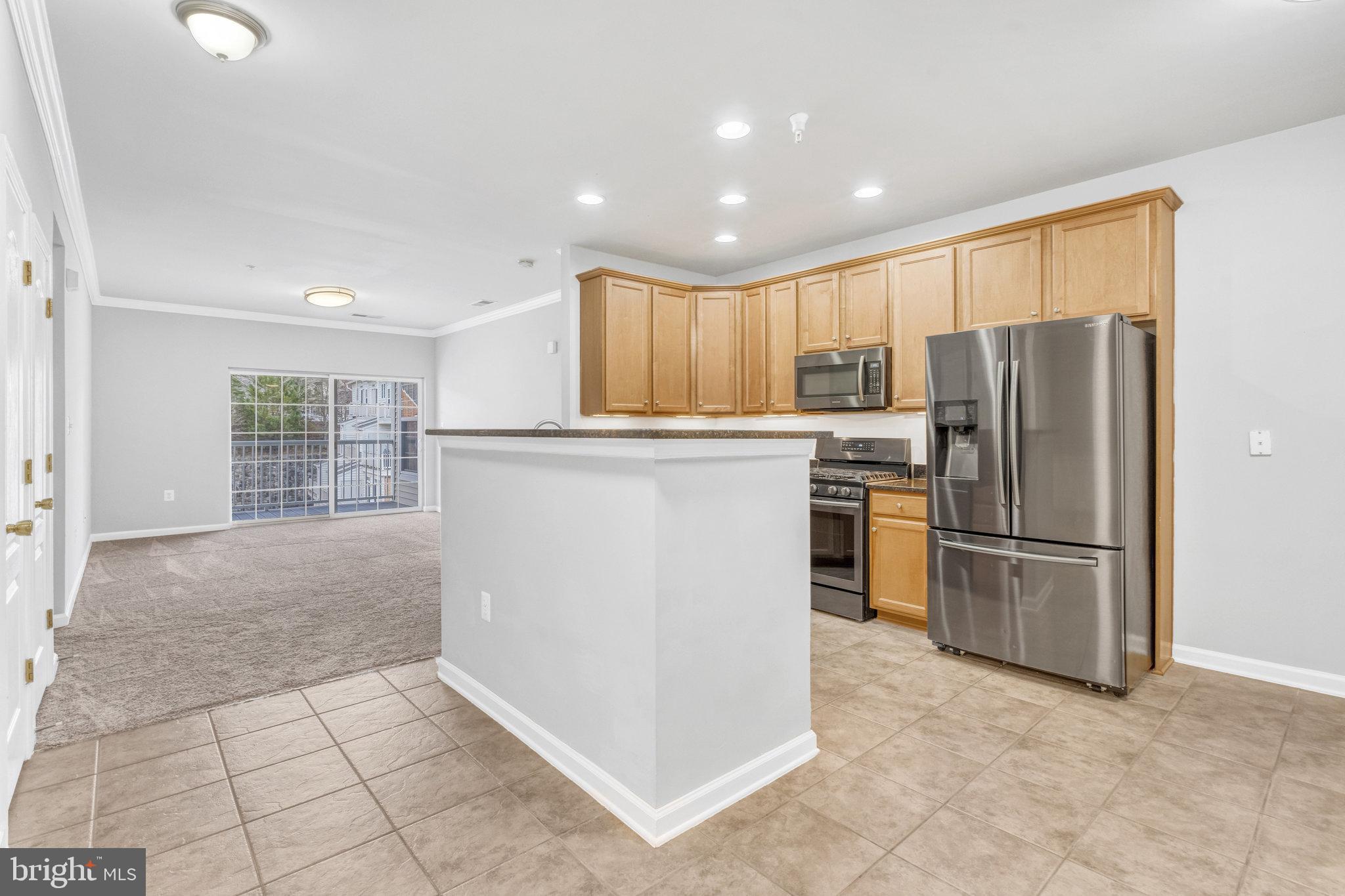 This is a Great 2 bedroom, 2 bath condo on the TOP LEVEL with 1 car expanded Garage and additional parking!

Open floor plan with high ceiling and plenty of natural light. The kitchen has room for table & includes stainless appliances, granite countertops and upgraded tile flooring. A truly separate dining room includes crown molding. Open living room leads to large balcony. The master bedroom includes a large walk-in closet and additional closet near master bath. The luxury master bath includes a soaking tub, separate shower, dual vanities, and ceramic tiles. Secondary bedroom is large, bright and sunny. Excellent commuter location, very close to VRE, shopping and dining. Condo fee includes water, trash/recycling, outdoor pool and snow removal. Parking can be in garage (K), owner's driveway, and reserved guest parking permit. Building has secure access with elevator.

You may Park in driveway in front of the garage door to the far right of the building front door. You'll see three garages with driveways. The garage with this unit is unit "K". The “K” appears on the walk-through door on the main floor hallway. You may also park on the main street.

SentriLock is labeled “Chip Rigby#403, and is on a metal bar to the LEFT of the front door near the gas meters. Fob is used to gain entry into the building. Use FOB at dial box in lobby.

Apply online through Management website. Resident Benefit Package is part of lease. Resident Benefits Package - $30/month Required with ALL lease agreements managed by Peake Management Inc. Peake provides a 24 hour Emergency Maintenance Hotline with Live Phone Support * High-quality air filters delivered to your home every other month! This keeps air clean and lowers your monthly heating & cooling bills and keeps you in compliance with your lease obligations. * Positive credit reporting for all on-time rental payments to credit bureaus. Could help raise your credit score! See resident brochure for more info. Resident Benefit Package charges are in addition to the rent each month.

Available February 1, 2024 Qualifications: 2 years of full-time employment history, 2 years of rental history (or home ownership), good credit, household income roughly $92,000 (for groups sharing, that would be the sum of the 2 lowest incomes).