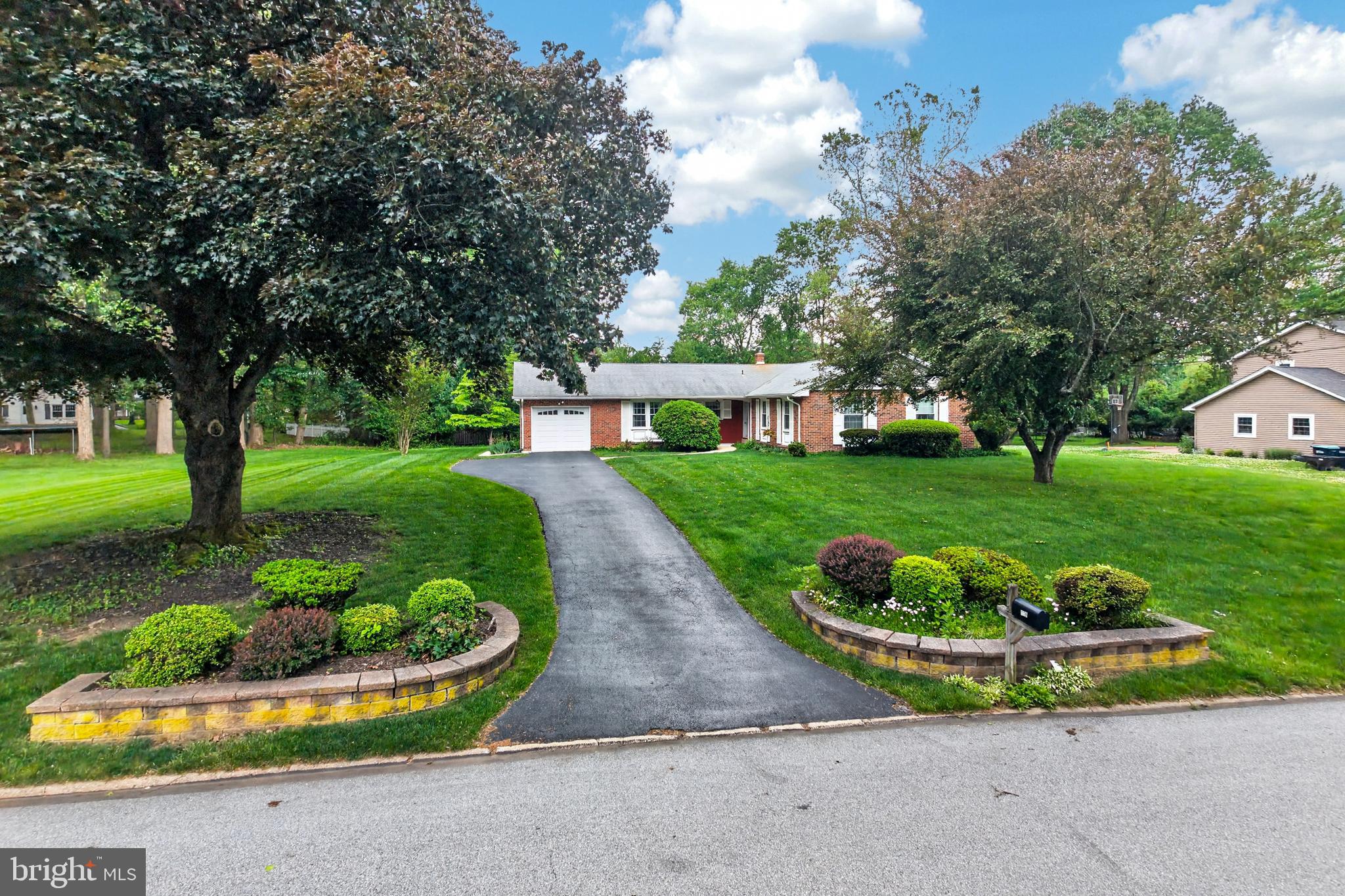 Spacious brick ranch homes in Marchwood don't come up often — and this one, lovingly maintained by its original owner, sits on a private .53-acre lot in a quiet section of the neighborhood. With 3 bedrooms, 2 bathrooms, 1,873 square feet of single-floor living , a level lot and a fantastic location, this is the one buyers have been waiting for.
The home offers a traditional and functional floor plan — formal living room, dining room, family room with brick fireplace, kitchen with refaced cabinets, eating area, and a convenient laundry area, all on one level. Three bedrooms and two updated full baths round out the main floor. The attached garage includes a shed addition accessed directly through the garage, adding useful storage and workspace. The unfinished basement provides excellent potential for additional living space down the road. Hardwood floors are featured under the carpeting in the bedrooms, living room and dining room.
Outside, the home has genuine curb appeal — a classic brick exterior, small covered front porch, and a level .53-acre lot that offers privacy. Marchwood is one of Exton's most popular communities, loved for its neighborhood feel, convenient location, and proximity to parks, shopping, the YMCA, train stations, and major routes — all within the award-winning Downingtown East School District and nationally recognized STEM Academy. Priced to offer exceptional value, this is a rare opportunity to own a home in Marchwood at an attainable price point while adding your own personal touches over time. Marchwood puts you minutes from parks, schools, the YMCA, Exton Library, shopping, ballfields, train stations, and the PA Turnpike — all within the award-winning Downingtown East School District and nationally recognized STEM Academy.