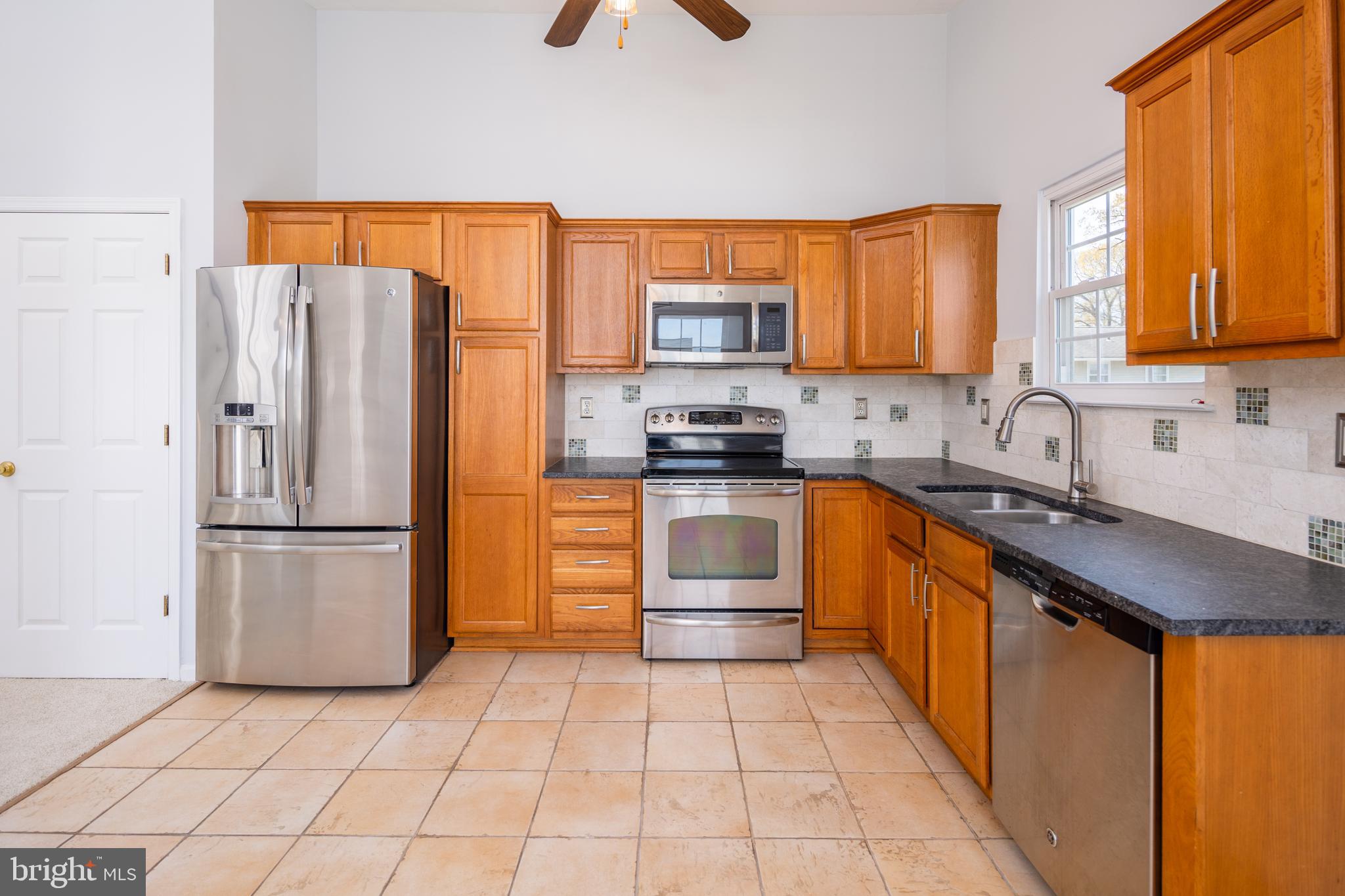 Move right into this spotless single family home with a sunny floor plan located in sought after Green Haven Neighborhood! Brand new neutral carpet & fresh paint making this home ready to move right in.  This home sits on a nice level lot with concrete driveway for multiple cars. Upstairs features a living room and a large kitchen with an eat-in dining area.  Down the hall are two generously sized bedrooms, full hall bath and a third bedroom which is your master suite with en-suite bathroom.  The lower level features a large fourth bedroom, full bath,  oversized laundry room, a huge bonus room that can be used as a den, office or additional living area, and a recreation room with a walkout to brick patio and fully fenced rear yard.  House is vacant and easy to show so schedule your showing today!