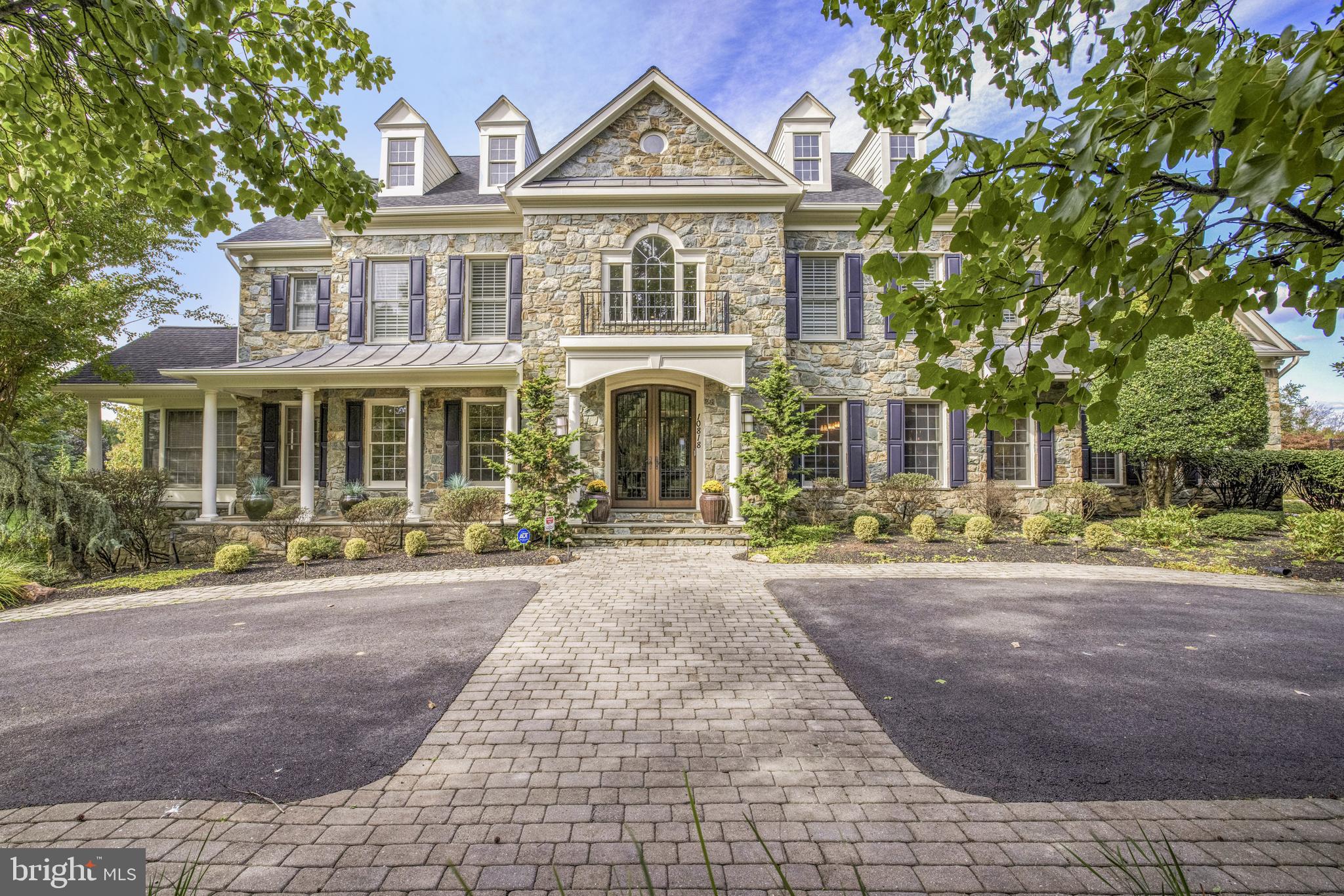 Prepare to be captivated by this stunning residence, built by Craftmark Homes in 2000 and situated on two beautifully manicured acres with lush landscaping and mature trees. This completely renovated home offers a peaceful, private retreat in a coveted Potomac suburb, featuring 8 bedrooms and 9.5 bathrooms across 8,947 square feet of exceptional living space in the sought-after Saddle Ridge community.

The home showcases refined interiors with impeccable attention to detail throughout. An abundance of windows flood the principal living spaces with natural light, while numerous fireplaces add warmth and comfort to every room.  

As you step through the elegant double glass and wrought-iron front doors, you're greeted by a grand two-story foyer with marble floors, a striking staircase and a stunning alabaster chandelier. The main level showcases a timeless design with a seamless flow, featuring a spacious living room with a gas fireplace, an elegant dining room, a bright conservatory, and a welcoming family room centered around a stunning stone gas fireplace. This level also includes a grand office, a full bath, and a powder room. The recently remodeled California contemporary kitchen—featured in Home & Design magazine—is a chef’s dream, complete with granite countertops, a large center island with breakfast bar, two dishwashers, custom cabinetry, and a breakfast room. This kitchen opens directly to the deck, making it perfect for indoor-outdoor entertaining. Off the kitchen, a mudroom with a full size Sub-Zero refrigerator and separate freezer adds convenience. The full bath on the main level allows for the easy conversion of the office to a bedroom.

Upstairs, the primary bedroom is a luxurious retreat, featuring high ceilings, multiple cedar walk-in closets, a sitting area with fireplace, and a spa-like ensuite bath with marble heated floors, two separate vanities, a soaking tub, walk-in shower, two walk-in closets and a linen closet. Four additional generously-sized bedrooms, each with their own ensuite baths, provide comfort for all.

A finished attic adds even more value, featuring skylights, an additional bedroom, full bath, and a dedicated office space.

The finished basement is designed for entertainment, with new LVP flooring, a wet bar, home gym, recreation room, billiard room, and full bath. The walkout lower level is perfect for multigenerational living with the additional bedroom and its own ensuite full bath.

Outside, the private oasis features a salt-water pool with a new pebbletec bottom, waterfalls and a connected hot tub. The fully fenced yard ensures privacy, while the gazebo and two Viking grills with gas lines provide a chic space for outdoor entertaining. The lush gardens and greenery create a serene setting for alfresco living.

This exceptional property also includes a four-car garage and a driveway pad ideal for basketball or pickle ball. The gated driveway enhances security and privacy, offering a welcoming and exclusive entrance.

Harmoniously blending traditional architecture, modern amenities, and luxurious comfort, this home has been meticulously maintained with recent improvements, including two commercial-grade hot water heaters; an interior and exterior surround sound A/V system; electric car charger (2022); new roof (2019), renovated primary bath (2020), kitchen remodel (2014); new HVAC (2020); ADT camera and alarm system (2020 & 2022); lower-level flooring (2023); upper-level hardwood flooring (2023); interior painting (2019) and exterior painting (2023).