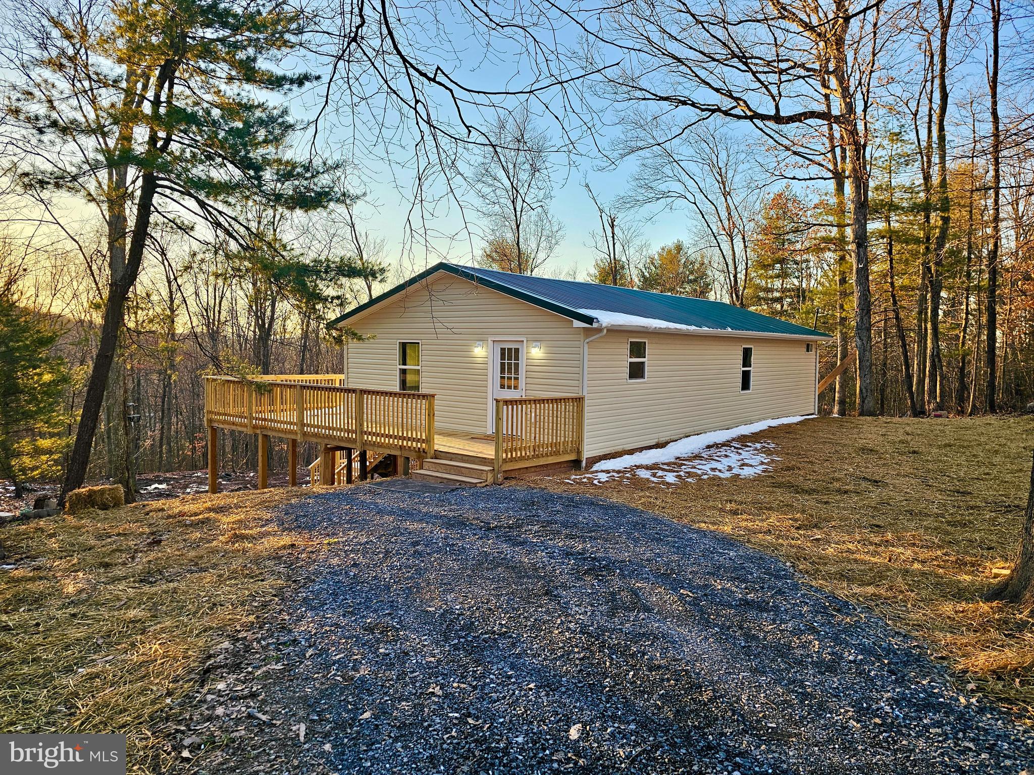 An ideal spot for anyone who needs easy access to modern amenities yet also wants to be "away from it all", 302 Edenwood Lane is definitely the one you've been searching for! Completely updated inside and out...from siding to the roof...new HVAC to floors...paint to appliances!  An easy breezy open main living space with a fantastic kitchen, dining area, and large living room makes this an ideal gathering space. Just down the hallway, you'll find the primary bedroom with gorgeous slider doors that step out onto the deck and its BREATHTAKING VIEW as well as a walk-in closet and private bathroom that is a "must see to believe"! Two additional bedrooms (one with deck access), a full bathroom, and a laundry area are also on this main floor. There is an unfinished partial basement that could be used for storage.