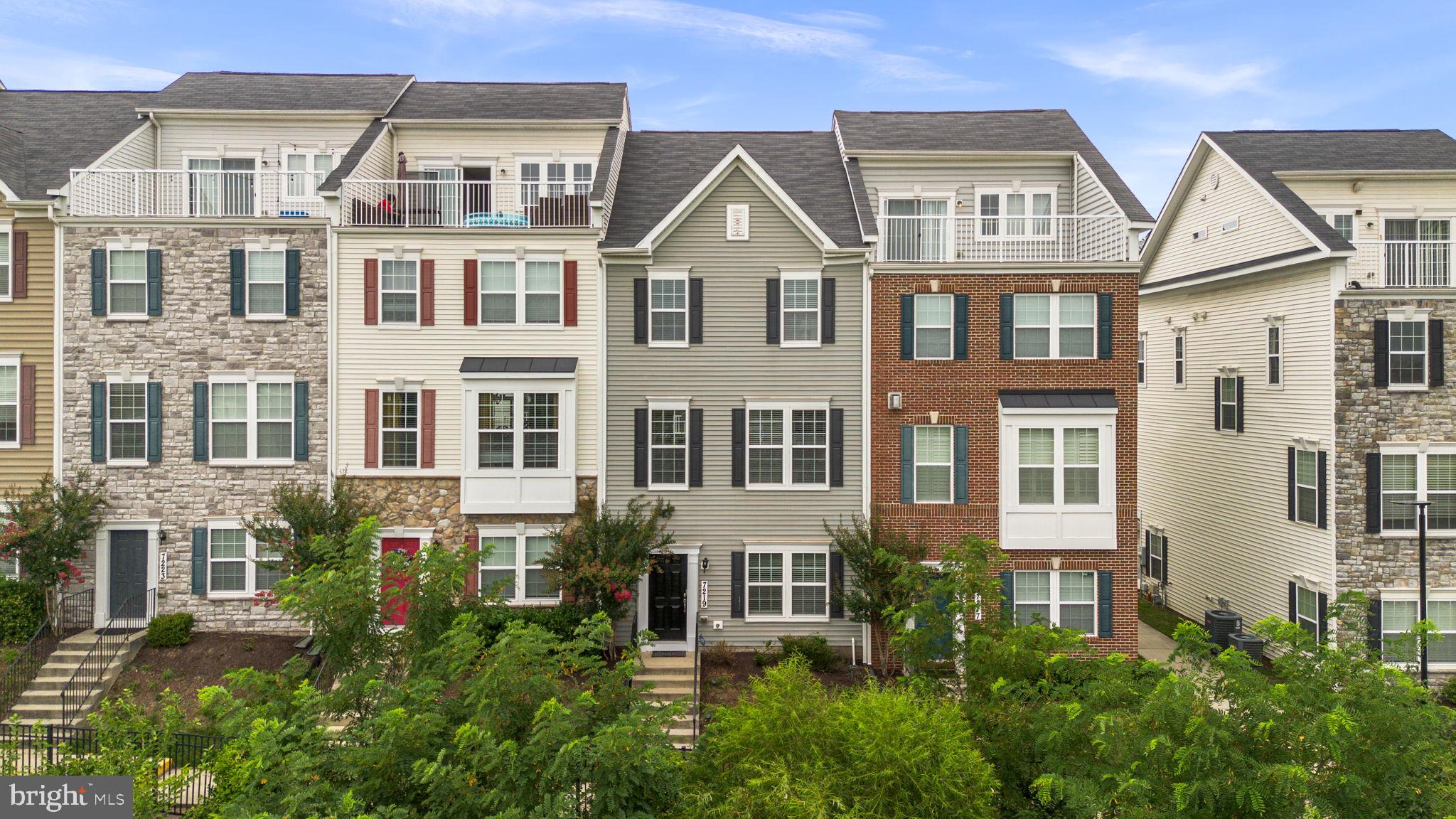 Beautifully maintained townhouse residence offering 4 bedrooms, 2.5 bathrooms, and 1,820 finished square feet in desirable Elkridge Crossing. // Step inside the welcoming entry-level foyer, where rich hardwood floors create a warm first impression. This level also provides convenient access to the attached two-car garage and features a comfortable carpeted bedroom that also serves as a versatile bonus space, ideal for a private home office, fitness area, or guest retreat. // Ascend to the bright, open-concept main level, where hardwood floors extend throughout the thoughtfully designed living spaces. The spacious living room is accented by a sparkling chandelier, while a conveniently located powder room adds everyday functionality. // Continue into the gorgeous eat-in kitchen, beautifully appointed with upgraded countertops, stainless steel appliances, a custom tile backsplash, pendant lighting, a pantry, and an oversized center island with breakfast bar seating. The adjacent dining area creates the perfect setting for everyday meals and entertaining, with sliding glass doors leading to a private balcony for seamless indoor-outdoor living. // The upper level hosts three generously sized, carpeted bedrooms, each featuring custom closet organization systems, along with two full bathrooms. The inviting owner's suite serves as a relaxing retreat, complete with a spacious walk-in closet and a private ensuite bath featuring a dual-sink vanity. A centrally located laundry closet adds convenience to the bedroom level. // Residents of Elkridge Crossing enjoy beautifully maintained common grounds and neighborhood tot lots and playgrounds, offering wonderful opportunities for recreation and outdoor enjoyment.