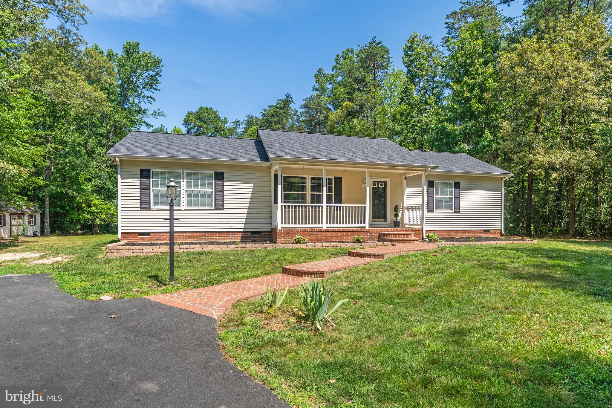 *** Move In Ready 3BR 2BA Home ***  3.8 acres ***No HOA*** Primary bedroom suite with custom tiled walk-in shower and large walk-in closet.  2 more generous sized bedrooms including walk-in closets.  All bedrooms now have new soft carpet.  Hardwood floors in the Family Room. Lots of brick work includes brick mailbox post, custom columns with lights and additional plugs entering your private driveway, sidewalk, and combination of brick and concrete country front porch and rear patio. Outside, is a backyard oasis, offering a serene escape where you can add a firepit or whatever you want. 2 sheds. Carport 26'x20. There is plenty of parking for your RV or boat, if desired. Roof 2021. HVAC 2023.