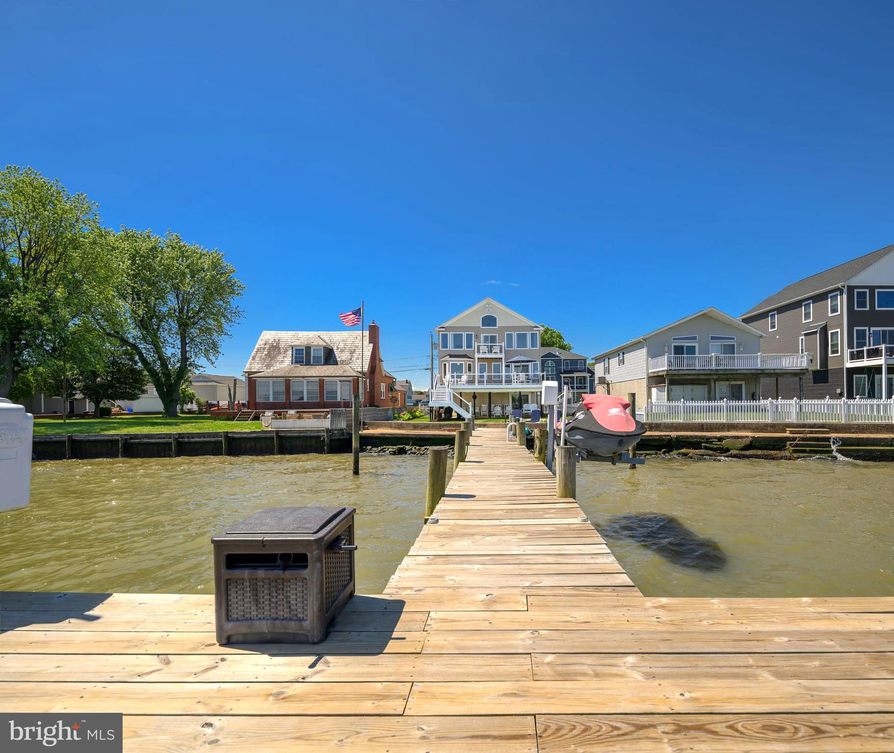 **Welcome to 7112 River Drive Road, a meticulously maintained waterfront retreat offering nearly 4,000 square feet of total space and breathtaking panoramic views that take center stage from nearly every room. Combining luxury updates, exceptional boating amenities, and thoughtfully designed indoor and outdoor living spaces, this extraordinary home delivers the ultimate lifestyle.
From the moment you step inside, soaring ceilings, gleaming hardwood floors, and expansive windows draw your attention to the spectacular water views. Natural light fills the home, while the family room offers a cozy gas fireplace and built-in surround sound, creating an inviting setting for both everyday living and entertaining.
The beautifully updated kitchen features Quartz countertops, recessed lighting, abundant cabinetry, an undermount sink, center island with storage, and Samsung Smart appliances installed in 2021, including a tablet-style refrigerator with water dispenser and ice maker. A 2026 kitchen addition created a charming breakfast nook where you can enjoy your morning coffee while taking in the tranquil waterfront scenery. Andersen sliding glass doors with built-in blinds, installed in 2023, open to a maintenance-free walk-down composite deck, seamlessly blending indoor and outdoor living.
The main level also includes two bedrooms, a full bath with porcelain tub from the original home, a laundry room with Smart LG washer, second washer (SideKick), and Smart dryer.
Upstairs, double doors lead to the luxurious primary suite, where oversized windows continue to showcase stunning waterfront views. This spacious retreat offers vaulted ceilings, brand-new carpet, a sitting area, a custom walk-in closet, and a private composite deck overlooking the water. The newly remodeled spa-inspired en-suite bath features a walk-in shower, freestanding soaking tub, double vanity, Smart LED mirror, Bluetooth exhaust fan, and a Smart toilet with bidet, heated seat, and auto-flush functions.
A previously unfinished attic has been transformed into a fourth bedroom/bonus room with new carpet, recessed lighting, updated electrical, built-in storage, and closet.
Outside, boating enthusiasts will appreciate the impressive 80-foot T-pier with water, electric, 30-amp shore power, two boat lifts (12,500 lb. w/Gem remote and 3,500 lb.), and a 1,500 lb. jet ski lift. 3 ft MLW and a hard sandy bottom, this property is ideal for boating, fishing, and water recreation. On clear days, the sellers note you can see the Eastern Shore from the end of the pier.
Additional features include concrete bulkhead, under-deck drainage, two sheds with maintenance-free platforms, a Polywood swing overlooking the water, a two-car attached garage, tankless gas water heater, Nest thermostat, generator hookup, fresh interior paint (2023), sealed driveway (2024), new shutters, front door, chandeliers, Hunter ceiling fans, and updated exterior lighting. The pier was redecked in 2020 with new end caps and hurricane straps added in 2024.
Flood insurance is only $565 annually. 
This exceptional property offers easy access to waterfront dining, fishing, and endless boating adventures. Experience the unmatched beauty of waterfront living and schedule your private tour today.