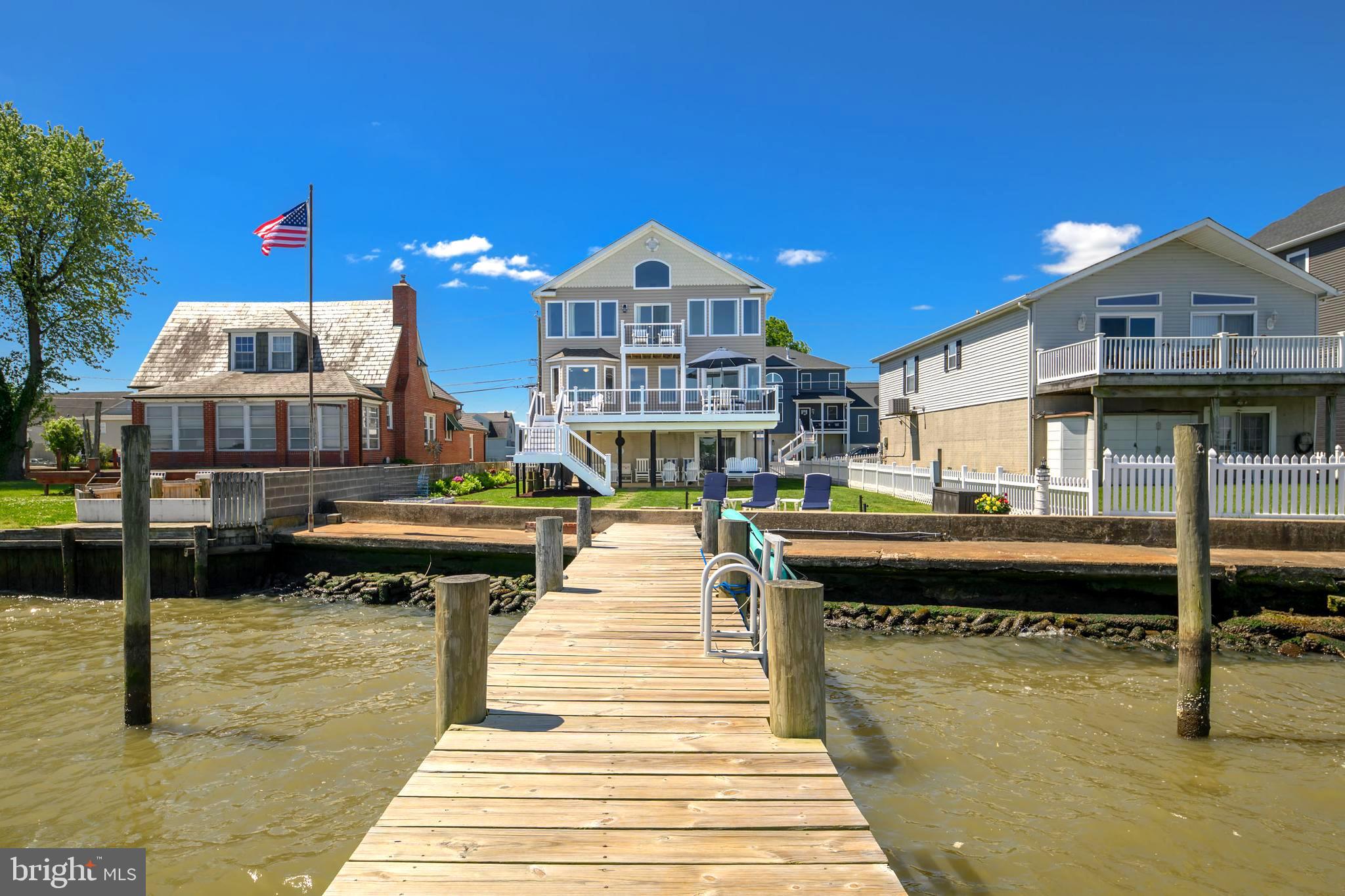 **OPEN HOUSE SATURDAY 6/13/26 FROM 11AM-1PM**Welcome to 7112 River Drive Road, a meticulously maintained waterfront retreat offering nearly 4,000 square feet of total space and breathtaking panoramic views that take center stage from nearly every room. Combining luxury updates, exceptional boating amenities, and thoughtfully designed indoor and outdoor living spaces, this extraordinary home delivers the ultimate lifestyle.
From the moment you step inside, soaring ceilings, gleaming hardwood floors, and expansive windows draw your attention to the spectacular water views. Natural light fills the home, while the family room offers a cozy gas fireplace and built-in surround sound, creating an inviting setting for both everyday living and entertaining.
The beautifully updated kitchen features Quartz countertops, recessed lighting, abundant cabinetry, an undermount sink, center island with storage, and Samsung Smart appliances installed in 2021, including a tablet-style refrigerator with water dispenser and ice maker. A 2026 kitchen addition created a charming breakfast nook where you can enjoy your morning coffee while taking in the tranquil waterfront scenery. Andersen sliding glass doors with built-in blinds, installed in 2023, open to a maintenance-free walk-down composite deck, seamlessly blending indoor and outdoor living.
The main level also includes two bedrooms, a full bath with porcelain tub from the original home, a laundry room with Smart LG washer, second washer (SideKick), and Smart dryer.
Upstairs, double doors lead to the luxurious primary suite, where oversized windows continue to showcase stunning waterfront views. This spacious retreat offers vaulted ceilings, brand-new carpet, a sitting area, a custom walk-in closet, and a private composite deck overlooking the water. The newly remodeled spa-inspired en-suite bath features a walk-in shower, freestanding soaking tub, double vanity, Smart LED mirror, Bluetooth exhaust fan, and a Smart toilet with bidet, heated seat, and auto-flush functions.
A previously unfinished attic has been transformed into a fourth bedroom/bonus room with new carpet, recessed lighting, updated electrical, built-in storage, and closet.
Outside, boating enthusiasts will appreciate the impressive 80-foot T-pier with water, electric, 30-amp shore power, two boat lifts (12,500 lb. w/Gem remote and 3,500 lb.), and a 1,500 lb. jet ski lift. 3 ft MLW and a hard sandy bottom, this property is ideal for boating, fishing, and water recreation. On clear days, the sellers note you can see the Eastern Shore from the end of the pier.
Additional features include concrete bulkhead, under-deck drainage, two sheds with maintenance-free platforms, a Polywood swing overlooking the water, a two-car attached garage, tankless gas water heater, Nest thermostat, generator hookup, fresh interior paint (2023), sealed driveway (2024), new shutters, front door, chandeliers, Hunter ceiling fans, and updated exterior lighting. The pier was redecked in 2020 with new end caps and hurricane straps added in 2024.
Flood insurance is only $565 annually. 
This exceptional property offers easy access to waterfront dining, fishing, and endless boating adventures. Experience the unmatched beauty of waterfront living and schedule your private tour today.