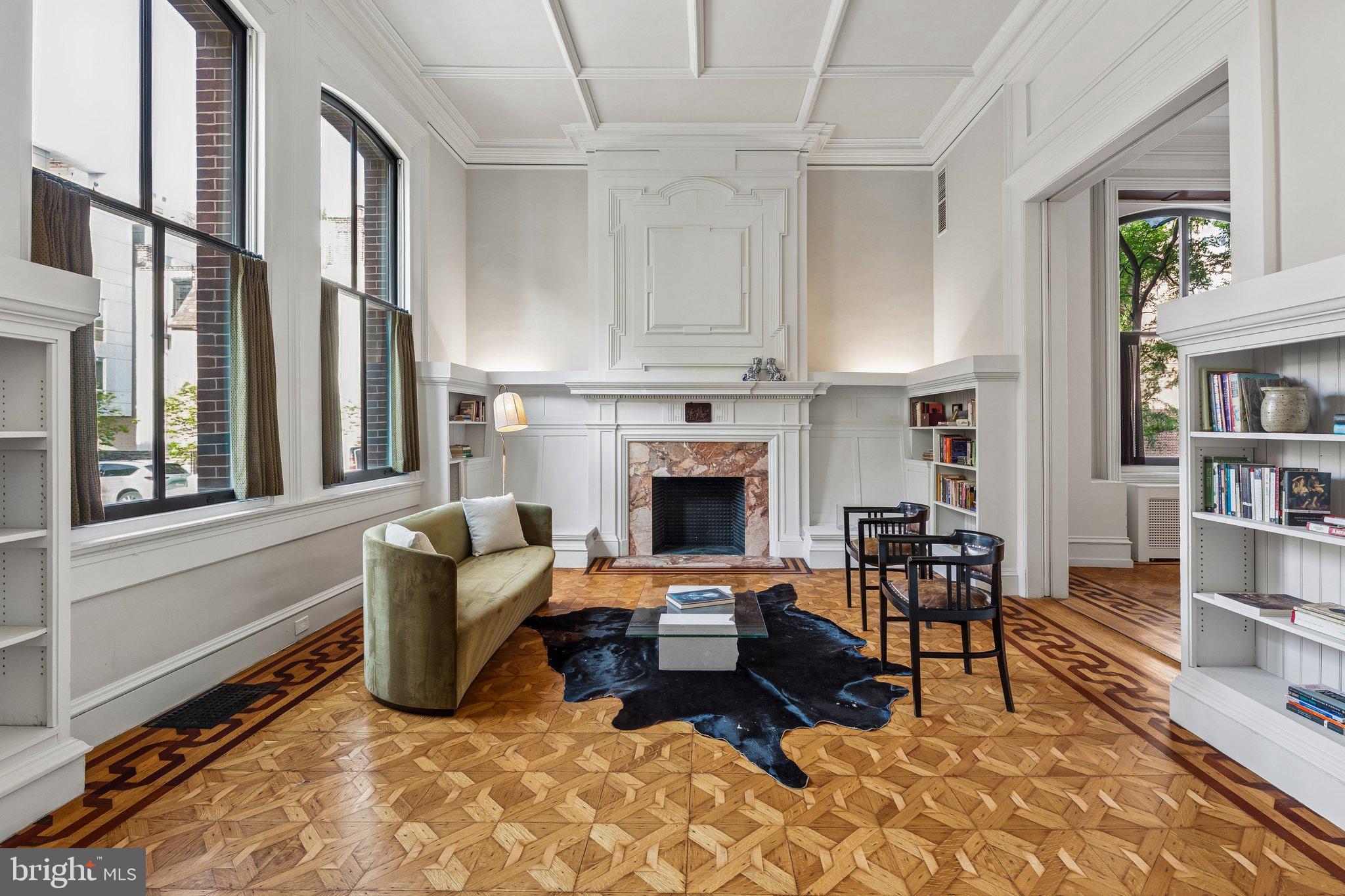 A singular opportunity in the heart of Rittenhouse, this exceptional corner townhome—constructed c. 1850—was originally designed by celebrated Philadelphia architect Frank Furness and meticulously restored by the current owners. Positioned at the intersection of 22nd Street and St. James Place, the five-bedroom residence offers sweeping views of the Philadelphia skyline alongside the tree-lined character of one of the neighborhood’s most historic blocks.
Defined by Furness’s bold architectural vision, the home is distinguished by soaring ceilings, dramatic proportions, and richly articulated architectural detail. A cantilevered bay extending over 22nd Street remains one of the property’s most distinctive features, underscoring its architectural pedigree.
A comprehensive 2021 renovation was guided by a clear principle: modernize without erasing. The result is a seamless integration of contemporary systems and historic character. Exterior work included full repointing of the brick façade, chimney restoration, new wooden corbels, and a complete roof replacement. Inside, plumbing, electrical systems, and most windows were fully updated, ensuring modern performance while preserving the integrity of the original design.
For a second renovation to the interiors completed last year, Vestige Home drew from Furness’s ornamental vocabulary to inform a series of custom details. The kitchen range hood, butler’s pantry bench, and primary suite built-ins incorporate geometric motifs that echo the architect’s distinctive style. Original mantlepieces, intricate millwork, and rich wood detailing remain intact, reinforcing the home’s authenticity.
The main level unfolds from a gracious entry hall with a grand staircase into formal living and dining rooms that balance historic character with a natural flow for everyday living and entertaining. The kitchen is anchored by a striking red marble island with generous seating and storage, complemented by quartz countertops and a full suite of high-end appliances. A cozy breakfast nook and a well-appointed butler’s pantry—with extensive storage, custom seating, and a second dishwasher—add both function and flexibility.
The second floor centers on a living area anchored by the large bay, where eastern exposure captures morning light and skyline views. The primary suite features large north-facing windows and a fully reimagined en suite bath with a custom vanity, walk-in wet room, soaking tub, and handcrafted zellige tile walls and arched ceiling. Two additional bedrooms and a fully renovated bath complete the level.
The third floor offers a flexible, self-contained living space with two bedrooms, separate living areas, a full bath, kitchenette, and in-unit laundry—ideal for guests, extended family, or a private workspace. Above, a stained glass skylight crowns the stairwell.
Located within the Greenfield School catchment and equidistant to Rittenhouse Square and Fitler Square, as well as the Schuylkill Banks, the home sits on an architecturally rich, tree-lined street. Sellers will provide a credit toward one year of parking at the buyer’s choice of a nearby garage. Moments from Walnut and Chestnut Street shopping and acclaimed dining including Vernick Food & Drink, Parc, Wilder, as well as neighborhood favorites Mr. Rabbit, Sally, and Ambrosia. Convenient access to 30th Street Station, University of Pennsylvania, Drexel University, Children's Hospital of Philadelphia, Hospital of the University of Pennsylvania, and Center City completes the offering. Make your appointment to see this outstanding residence today!