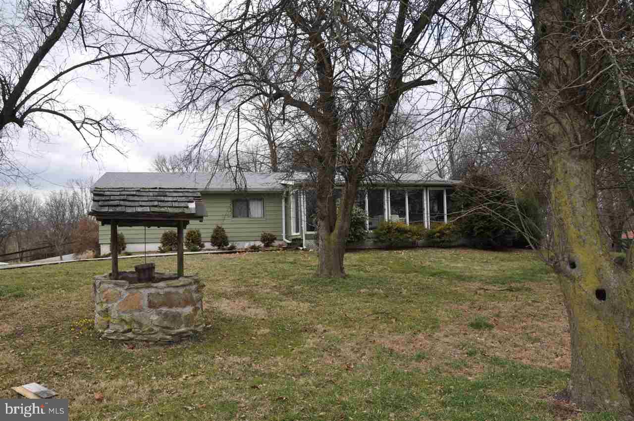 Enjoy watching nature from your living room or sun room. Peaceful views from every corner. Well kept home with 4BR, 2.5 bath, finished basement, and 2-car built-n and 4-car detached garages. Other vacant lots surround home and are available to buyer with purchase of home.