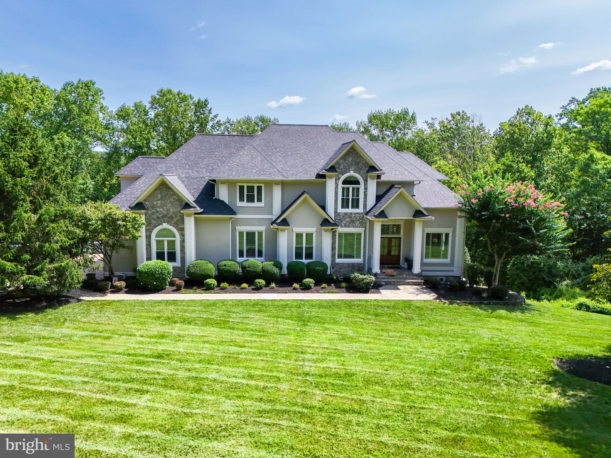 Discover unparalleled elegance and tranquility in this stunning luxury residence, nestled on a generous lot that offers the ultimate blend of seclusion and sophistication. This extraordinary home boasts 4 bedrooms, 4 1/2 bathrooms, and a thoughtfully designed layout that harmoniously blends comfort with style.

As you approach this magnificent property, you’ll be greeted by a grand façade and a large 3-car side-load garage, providing ample space for your vehicles and additional storage. Step inside to experience an inviting atmosphere enriched by exquisite finishes and meticulous attention to detail.

The heart of the home features an expansive living area highlighted by a cozy gas fireplace, perfect for unwinding or entertaining guests. Adjacent to the living space is a gourmet kitchen that will delight any chef, complete with high-end appliances, custom cabinetry, and a spacious island.

Entertain, workout, and play in the lower level 10'+ ceilings and with a wet bar featuring its own cooktop are highlights to the space that walks out on to the lower-level of the outdoor deck.

Each of the four bedrooms is a private retreat, designed for relaxation and rest. The primary suite is a sanctuary of luxury, offering a spa-like en-suite bathroom and a generous walk-in closet.

Step outside to your own personal oasis—a private 2-level outdoor deck that seamlessly blends indoor and outdoor living. Here, you can enjoy serene views of the lush trees and meandering creek that runs through the property, creating a picturesque backdrop for al fresco dining, lounging, or simply soaking in nature’s beauty. With no homeowner’s association, you have the freedom to enjoy your outdoor space as you see fit.

This property epitomizes luxury living, providing the perfect escape while still being conveniently close to all that you need. Don’t miss the opportunity to make this extraordinary home yours. Schedule your private tour today and experience the epitome of refined living in a tranquil, natural setting.