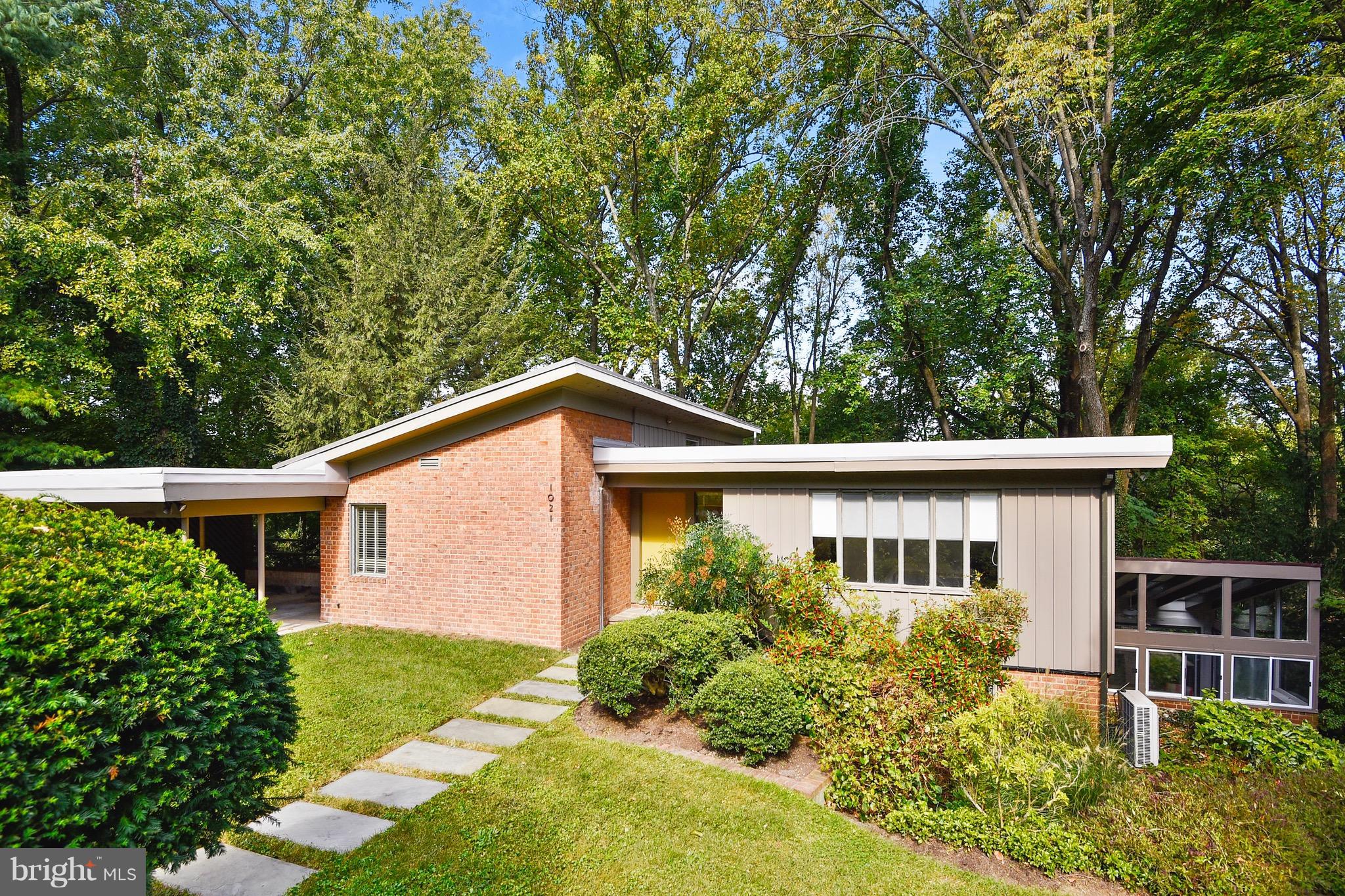 A mid-century oasis situated on a lovely wooded lot in Poplar Hill, not far from Whole Foods and Starbucks. This deceptively large three story home has spacious, light filled rooms including a tastefully updated kitchen with custom maple cabinets, slate floor, and stainless steel appliances. A bright sun room sits off of the kitchen/family room area with a deck running the length of the house.