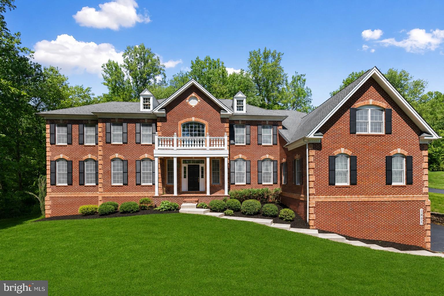 Welcome to this stately colonial home situated on a picturesque 1.21-acre lot in the sought-after Morning Brook community in Forest Hill. This impressive brick-front residence offers exceptional curb appeal with a covered brick front porch, concrete walkway, attached side-load 3-car garage, and expansive asphalt driveway for additional parking. Backing to mature woods, this home combines elegance, space, and privacy with luxurious finishes throughout.

Step inside the grand 2-story foyer featuring hardwood floors with bedroom overlooking balconies, chandelier, dual curved staircase with runner and metal balusters, and dramatic palladium windows that fill the home with natural light. The formal living room showcases crown and chair molding and opens to a bright adjoining sunroom with casement windows and recessed lighting. The center hall is accented with hardwood flooring, architectural columns, and spacious coat closets. Entertain in the formal dining room complete with crown molding, picture frame molding, chandelier with decorative rosette, and elegant wall sconces.

The main level office offers a quiet workspace with a bay window, while the spectacular 2-story great room features coffered ceilings, a floor-to-ceiling stone gas fireplace with mantel, ceiling fan, and plush carpeting. The gourmet kitchen is designed for both everyday living and entertaining with a large center island with breakfast bar and pendant lighting, granite countertops, rich wood cabinetry with glass inserts, designer tile backsplash, undermount cabinet lighting, walk-in pantry, all stainless steel appliances including a gas cooktop and wall oven, plus a spacious breakfast nook with table space and chandelier . An additional family room with hardwood flooring and recessed lighting provides even more gathering space. Two powder rooms with ceramic tile floors and pedestal sinks complete the main level.

Upstairs, the hardwood upper hallway overlooks both the foyer and great room below. The luxurious primary suite features a lighted tray ceiling, spacious sitting room, and walk-in closets with custom closet systems and versatile area that doubles as a dressing room, sitting room, or private office. The attached spa-like primary bath offers dual vanities with makeup area, two separate water closets, jetted garden tub, and walk-in shower with built-in bench, dual showerheads, and accent tile. Four additional bedrooms - two bedrooms have their private ensuite baths with shower/tub combo and single vanities and two bedrooms connected by a Jack & Jill bath.

The finished lower level is ideal for entertaining with a large rec room, wet bar with granite countertops, brick gas fireplace with mantel, full bath, and walk-up access to the rear patio and interior access to the 3-car garage. Additional basement features include a sauna, storage room, and unfinished space for future expansion or additional storage. 

Enjoy outdoor living on the rear paver patio with retaining wall and built-in seating backing to peaceful wooded surroundings on the expansive 1.21-acre lot. A truly exceptional home offering luxury, functionality, and timeless design in one of Forest Hill’s premier communities.