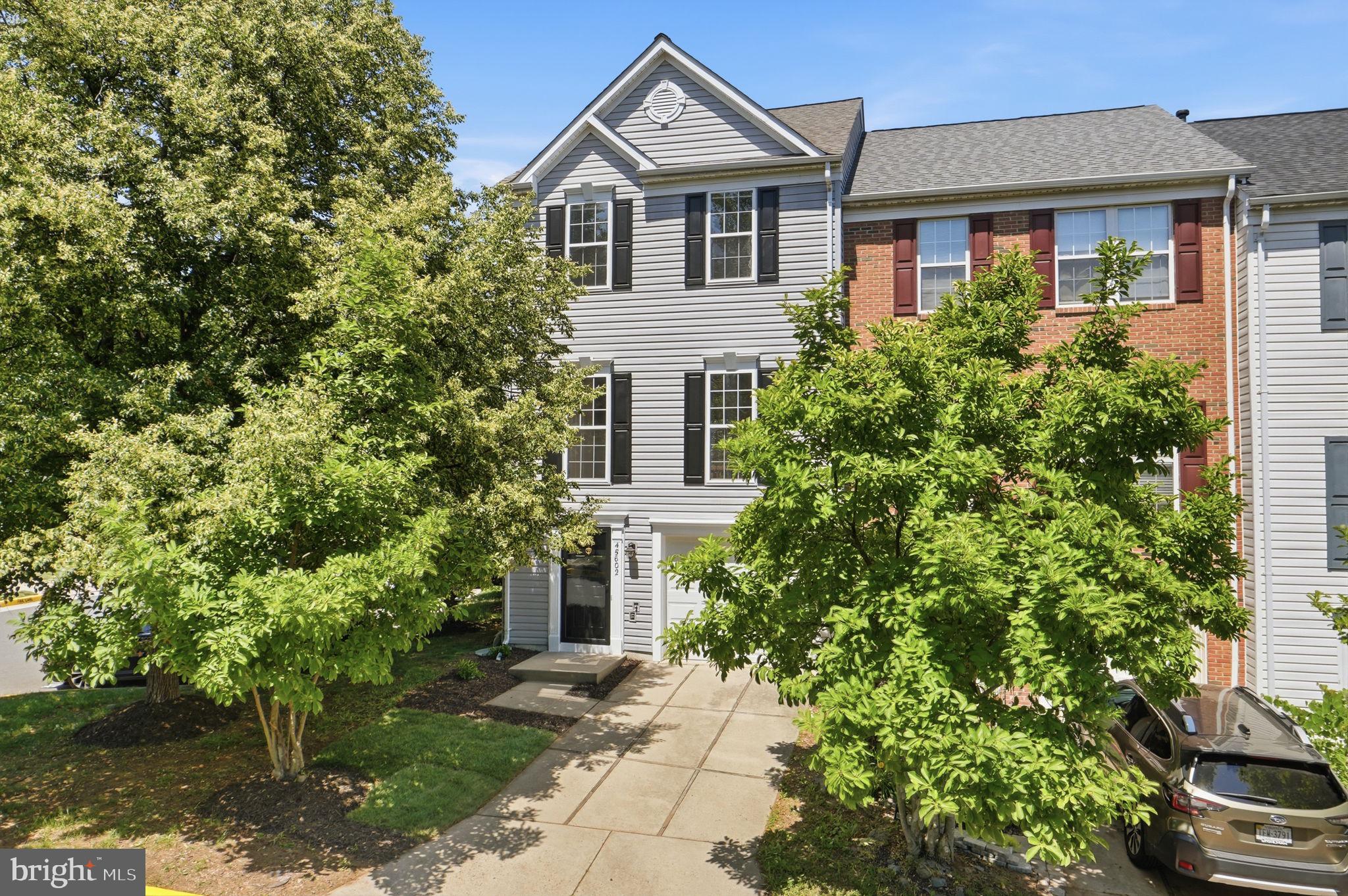 Welcome to this beautifully appointed three-level end-unit townhome located in the highly desirable Dominion Station community of Sterling. Perfectly positioned on a premium lot, this residence offers exceptional natural light, added privacy, and the space and flexibility today’s lifestyle demands. The main level features 9-foot ceilings and an open-concept design with seamless flow between the living, dining, and kitchen areas—ideal for both everyday living and entertaining. The thoughtfully updated kitchen features new cabinetry, sleek quartz countertops, tile backsplash, new stainless sink — a space that feels fresh, modern, and move-in ready. Just off the kitchen, a bright sitting area flows seamlessly onto the deck — perfect for your morning coffee or evening gatherings. A powder room completes the main level with both function and flair. Upstairs, all three bedrooms feature soaring vaulted ceilings, creating an airy, light-filled retreat. The spacious primary suite includes a step-in closet and a spa-inspired private bath with a soaking tub, new double vanity, quartz countertops, new shower tile, fixtures, and flooring. Two additional bedrooms share a beautifully updated full hall bath complete with a new vanity, modern lighting, and new flooring. The fully finished lower level, with a cozy gas fireplace, provides additional living space with a flexible layout that can function as a recreation room, media space, fitness area, or office, and it features a half-bath and offers convenient access to storage and utility areas. A dedicated laundry closet with a full-size washer and dryer adds everyday convenience. Outside, unwind on the paver patio, accented with river pebbles — a fenced, private outdoor retreat framed by mature trees. Recent major updates include: Kitchen renovation (2026), master and guest bath renovation (2026), new washer/dryer (2026),  new water heater (2025), new AC (2024),  new roof (2018), garage door (2019), carpet throughout (2026), new light fixtures (2026), fresh interior paint (2026), solid hardwood flooring main level (2020), new patio and deck sliding doors (2020), new window panes (2016). As an end-unit, this home enjoys extra windows, enhanced natural light, and a greater sense of privacy compared to interior units. Outdoor living is complemented by a private setting and access to community amenities, including a pool, tennis/pickleball court, clubhouse, strolling paths, and nearby access to the W&OD Trail. Ideally located near Dulles Airport, Route 7, Route 28, shopping, dining, and commuter routes, this home combines comfort, convenience, and lifestyle in one of Loudoun County’s most sought-after neighborhoods.