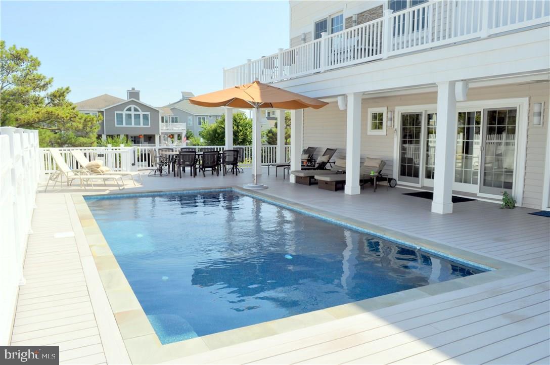 This is The Ultimate Beach House! It's features are sure to exceed your expectations and beyond! 6000 sq ft, 6 Bedrooms , 7 full and 2 half baths, elevator, Bay & Ocean views. Designer tile, granite, lighting & fixtures are throughout! All windows have electronic shades as does the screen porch that overlooks Rehoboth Bay! The 3rd floor features an open floor plan and a gourmet kitchen any top designer would be proud of. It's complimented with generous dining and living areas, a beautiful office, half bath, stunning master BR with his and her baths joined by a shared rain shower, built in cabinetry in hallway and walk-in closets, private laundry, and much more! The 2nd floor features 4 luxurious bedrooms each en suite, 2nd laundry room, a family room that opens to the pool, heated by solar & gas. There you'll also find a half bath & outside shower. The 1st level features an entrance foyer, 6th BR & full bath, exercise room, lg. storage room, his & her garages, paver drive & more!