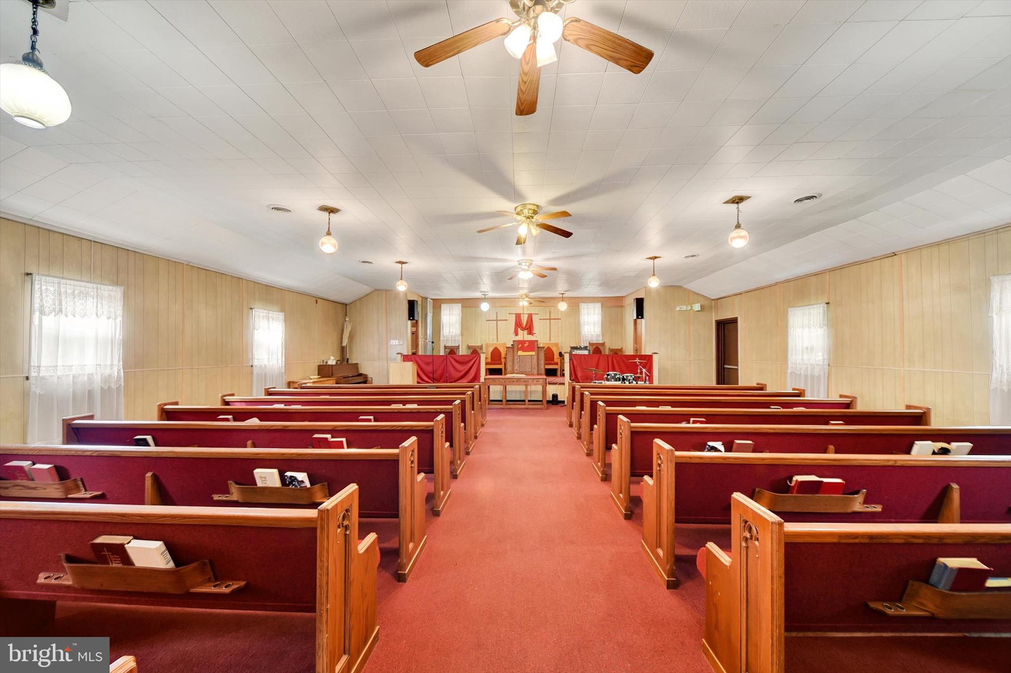 Fantastic opportunity to own a versatile church property with endless possibilities! Offering approximately 4,800 sq. ft. of space, this building features a carpeted main sanctuary with seating for around 100, complete with pews, pulpit area, and ceiling fans. The lower level accommodates up to 75 people at tables, making it ideal for fellowship meals, classrooms, meetings, or community events. The kitchen is equipped with a refrigerator, stainless steel sinks, microwave, gas stove, and oak cabinetry, providing everything needed for gatherings and events. Additional highlights include gas heat, hot water, double-pane windows, and both ramp and stair access for convenience. This property offers great potential for a variety of uses—church, community center, daycare, event space, or conversion opportunity. *Seller financing considered*

24-hour notice required for all showings.