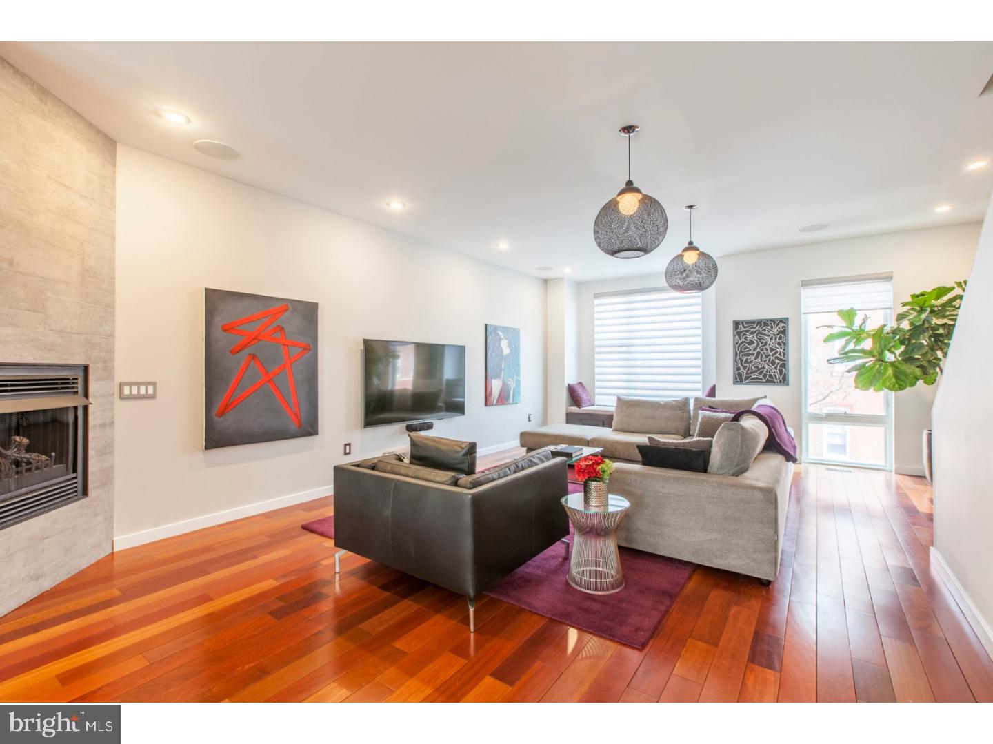 You absolutely cannot ignore this remarkable 4 bed, 3 bath fully decked out stunner in Fairmount. Tax Abatement until August 2022! More upgrades than you can believe! The tiled foyer welcomes you to the ground floor, featuring a light-filled, double-doored bedroom/office, full bathroom, and entrance to the large finished basement, which is currently serving as an in-home gym with removable padded flooring but can easily be changed into the man cave or playroom. In the back, a mudroom leads out to the huge 2-car garage with custom shelving and Granite-color epoxy flooring. Back inside, travel up the stairs (with high-end carpet runners, of course) into the open floor-plan living space. Check out those striking Brazilian Cherry hardwood floors! You'll see the dining area and fully equipped kitchen, with built-in stainless steel KitchenAid appliances, large island with bar seating, wine fridge, and dark wood cabinetry. You'll be the host-with-the-most in the expansive living room, boasting a remote-controlled gas fireplace, customized built-in Alexa-enabled smart blinds, and cozy window seating area. Make your way upstairs to the third floor - you'll find two equal sized bedrooms, a full bathroom, conveniently located Frigidaire Affinity Washer/Dryer, and a gorgeous Master Suite. This suite's beautiful double-sink master bath with large shower is positioned to receive direct sunlight. The bedroom's spacious customized walk-in closet, recessed lighting, and smart blinds ooze luxury. One more flight up to the rooftop oasis, complete with Jacuzzi hot tub, gas line hookup for a grille, entertaining space, and stunning Center City skyline views. This property has too many upgrades to name here, but here are some highlights: built-in speaker system w/ all necessary AV equipment included, Ring smart doorbell system, Kevo smart lock, and kitchen water filtration system with chilled faucet (forget that bottled water). Convenient to the Schuylkill for an easy commute, and all the Art Museum area has to offer, you do not want to sleep on this beauty.
