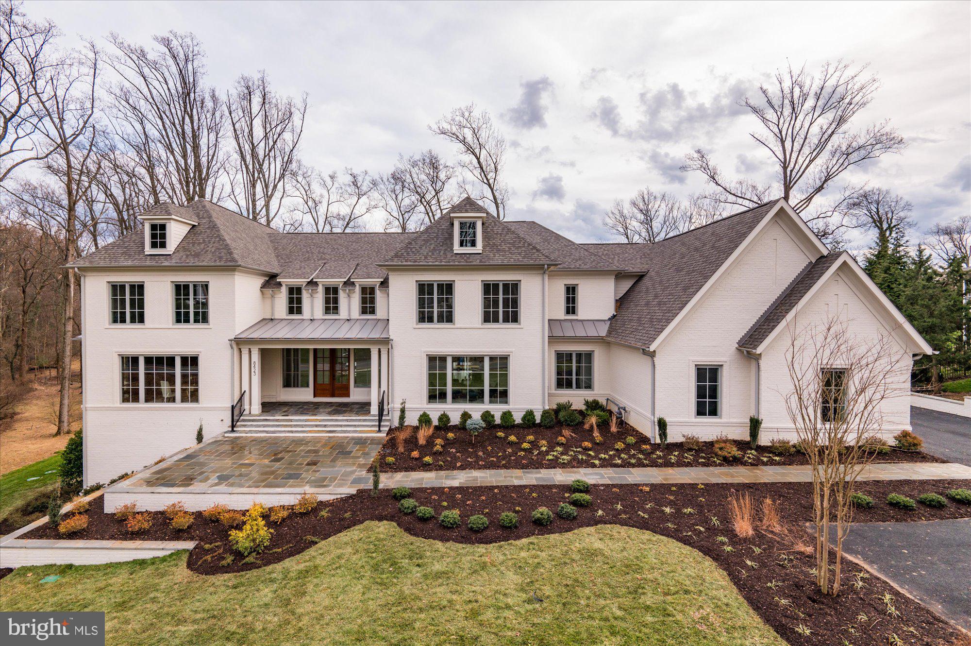 Cherry Hill Custom Homes proudly presents 8423 Brook Rd. This magnificent Manor style home sits on a picture perfect 1.7 acre lot with mature hardwoods and breathtaking views. The lot backs to over 12 acres of beautiful, open, green common space surrounding the Dogwoods neighborhood. This home features 6 bedrooms, 6 full bathrooms, and two powder rooms with 11,081 square feet of finished living space on three levels, dual staircases, attached four car garage, and an elevator shaft for optional conversion. The main level boasts 10ft ceilings, gorgeous white oak floors, a gourmet kitchen with paneled Subzero refrigerator and freezer columns and Wolf range, frame-less custom cabinetry and quartz countertops, a rear kitchen with refrigerator and freezer drawers, a 2nd dishwasher, and wine refrigerator.  The great room opens up to a screened porch with built-in heaters, speakers and phantom screens and is surrounded by a sprawling terrace with gas stub for grilling. A large guest suite, a private study, and an elegant formal dining room complete the main level. The upper level is highlighted by a luxurious owner's suite with the closet of your dreams and a spa-like bathroom with heated floors, double vanities, stand-alone soaking tub, and heavy glass enclosed shower. A reading nook, lounge area, and an expansive laundry room with island and built-ins rounds out the upper level.  The lower level is an entertainer's paradise with radiant heat in floors, a rec room with gas fireplace, wet bar with beverage refrigerator, an exercise room, an additional bedroom with full bathroom, a flex space for a wine cellar or media room, and a large storage area.  The walk-out basement features 12 foot ceilings and abundant natural light through the staircase and sliding doors leading out to a stone loggia and screened porch. Plenty of room for a swimming pool in the back yard. A 24kw whole home generator and a built-in irrigation system is included. Convenient to Tysons, McLean, and Spring Hill Rec Center. Spring Hill ES/ Cooper MS/ Langley HS.