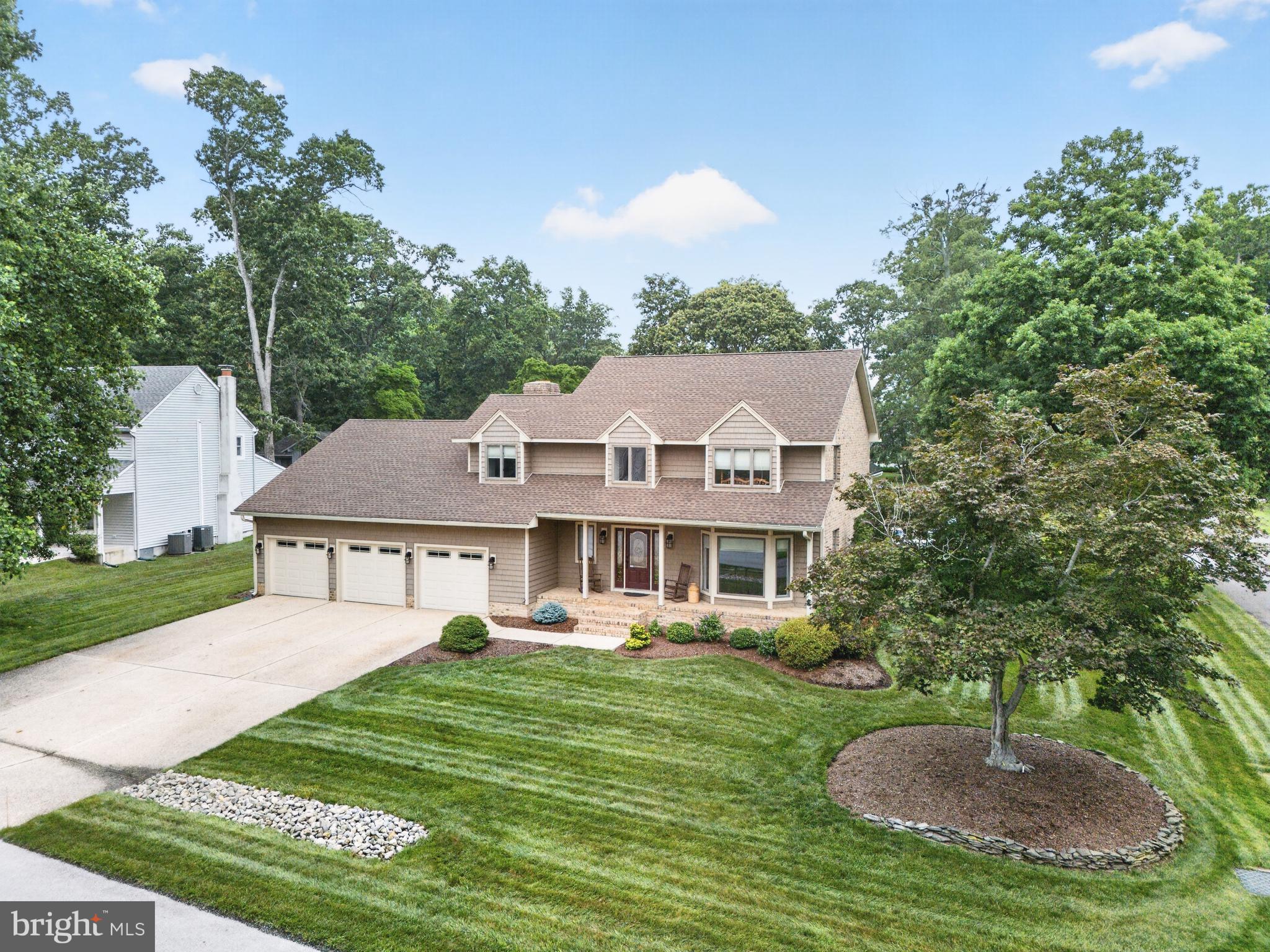Classic charm in Rehoboth Beach Yacht & Country Club! This beautifully maintained 3-bedroom, 2.5-bath home features a three-car garage and 2500 +/- square feet of thoughtfully designed living space, timeless quality, and exceptional curb appeal on a beautifully landscaped corner lot in a picturesque section of RBYCC.  Designed for both everyday living and entertaining, the home features formal living and dining rooms, hardwood floors, and a family room with a gas fireplace, brick surround, and built-in wet bar. The kitchen offers stainless steel appliances, double wall ovens, and a sunny breakfast area with a bay window. The 2nd floor primary suite is a private retreat with an updated bath featuring heated tile floors, a custom walk-in tiled shower, jetted soaking tub, and dual vanities. Two additional bedrooms and an updated hall bath provide comfortable accommodation for family and guests. Enjoy outdoor living on the screened porch complete with a built-in hot tub and grill, while the .28-acre corner lot offers beautiful landscaping, an irrigation system, and plenty of room for a future pool. Recent updates include new vinyl siding, a durable 50-year shingle roof, and updated HVAC for added peace of mind. Ideally located just minutes from downtown Rehoboth Beach, shopping, restaurants, the beach, and boardwalk, this home offers the perfect combination of comfort, quality, and coastal convenience.