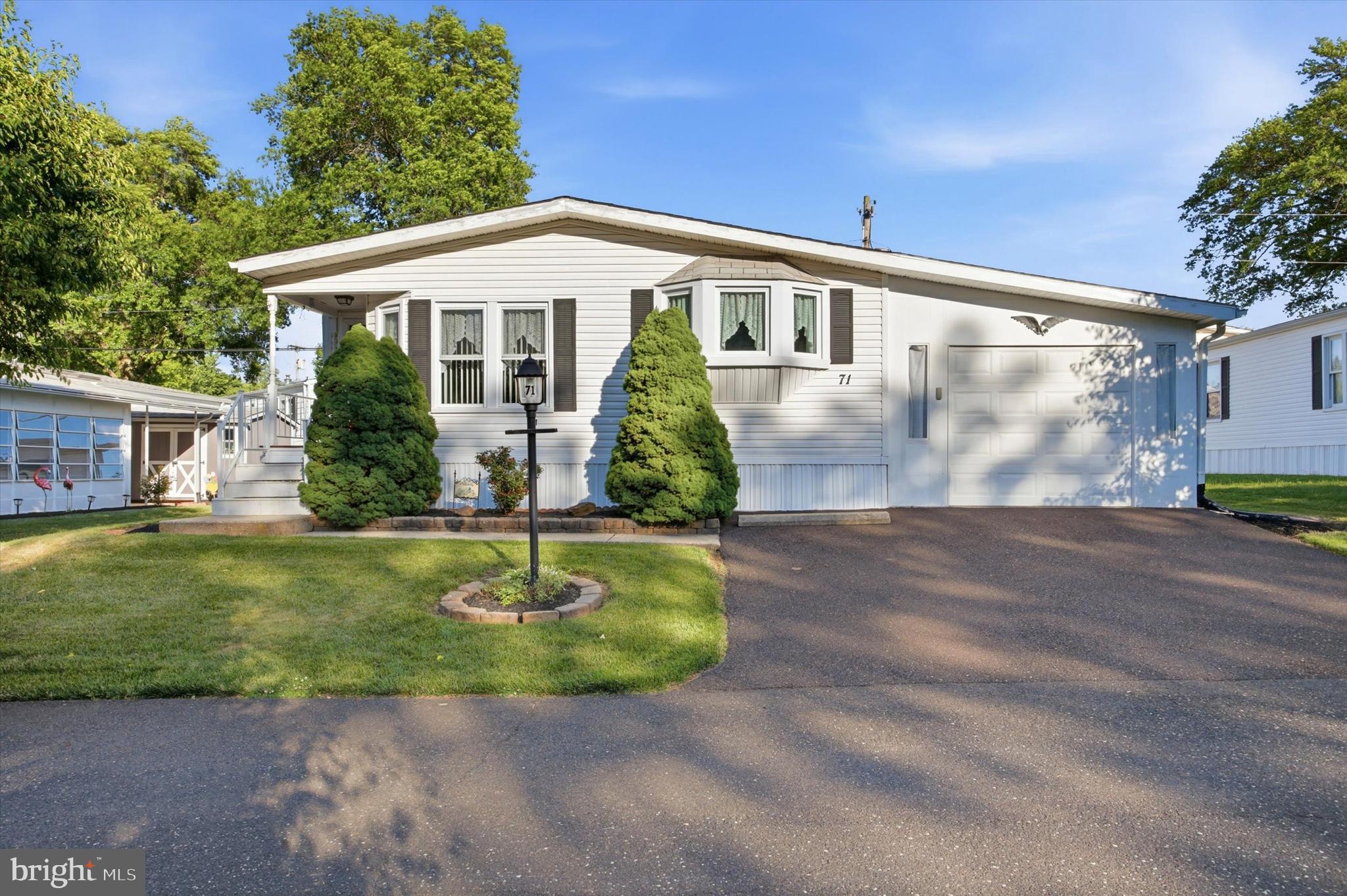 Welcome to 71 Cowbell Lane, a bright and well-kept home in the meticulously maintained Little Farm Estates 55+ community in a highly desired location. 

From the curb you get mature landscaping, a lamppost-lined walk, and something many neighbors don't have: a true attached garage with an opener.

Inside, the open living and dining area is wide and sunny, featuring vaulted ceilings, rich wood trim, and a large bay window that pulls in light all day. The eat-in kitchen is the heart of the home, offering ample oak cabinetry, a wall oven, a gas cooktop, a bright breakfast nook, and charming stained glass accents.

The home has two generously sized bedrooms and two full baths across roughly 1,458 square feet of easy single-level living. The primary suite has its own bath and a large walk-in closet.

The big stuff is handled. A brand new gas hot water heater, newer gas furnace, and central air mean you can move right in. Come see what easy living looks like today.