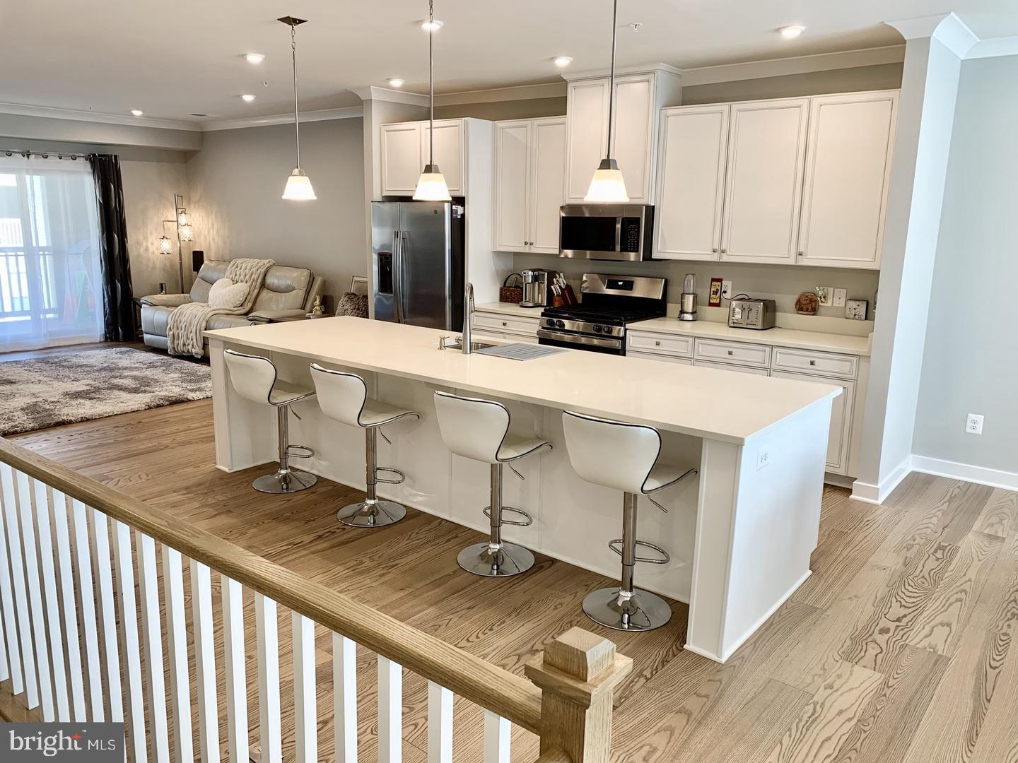 This recently built, completely upgraded, mirroring the model, spacious 2500+ sqft, 3-bedroom, 2.5-bath, townhouse style condo is truly move in ready. Main level features: open concept living with upgraded hardwood flooring, a gourmet kitchen with quartz counter tops, oversized center island, upgraded white cabinets, and stainless-steel appliances, and with two sliding glass doors leading to the large balcony off of the sun filled family room. The impressive primary bedroom includes a beautiful tray ceiling and two walk-in closets. Enjoy the relaxing spa-like primary bathroom with dual vanities and a spacious stall/roman shower with dual shower heads. Laundry room is conveniently located on the upper level with upgraded Washer and Dryer, folding station and upgraded storage cabinets. One car finished garage plus driveway to park. Close to shopping and dining, hiking and biking trails. Walking distance to Dulles Landing shopping Center. Arcola Town Center features an outdoor pool, clubhouse, fitness, tot lots, party room and conference/office spaces. Condo is located in a very close vicinity to all amenities. In close proximity to most major highways (Rte. 50, Loudoun County Parkway, 267 Greenway/Toll). Close to Dulles International Airport. Water and sewer are included in the rent.