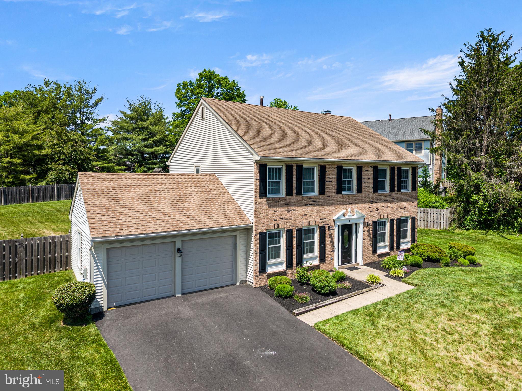 Welcome to 6 Goldenrod Court — a beautifully maintained 4-bedroom, 2.5-bath colonial tucked away on a quiet cul-de-sac in the highly desirable Newtown Grant community. Situated on an expansive, fully fenced lot, this home offers the perfect blend of space, comfort, and functionality both inside and out. Step inside to a bright foyer flanked by a formal living room and dining room, creating an inviting layout for both everyday living and entertaining. The spacious eat-in kitchen features abundant cabinetry, gas cooking, and a seamless flow into the sunlit family room complete with hardwood flooring, a stunning brick wood burning fireplace, built-in shelving, and recessed lighting. Just off the main living area, a versatile bonus room provides the ideal space for a home office, playroom, or sunroom overlooking the backyard. Upstairs, the oversized primary suite offers a peaceful retreat with ample closet space and a beautifully updated en-suite bath.  An additional highlight in the primary suite are two more rooms off of the main bedroom area that can be used as an office, nursery, extra walk in closet area, home gym- the possibilities are endless! Three more generously sized bedrooms and a full hall bath complete the second floor. Outside, enjoy one of the largest lots in the neighborhood with a fully fenced backyard, patio area for outdoor dining, and plenty of room for play, pets, or future outdoor enhancements. Additional highlights include a two-car garage, main floor laundry room, recessed lighting, and excellent curb appeal. Enjoy all the incredible benefits of being located in Newtown Grant- including a beautiful outdoor pool, beach volleyball, basketball, pickle ball courts, walking trails, game room, clubhouse, and so much more. Located within award-winning Council Rock School District and just minutes from shopping, dining, parks, and all that Newtown has to offer — this is a rare opportunity to own a move-in ready home in one of Bucks County’s most sought-after neighborhoods. Schedule your private tour today.