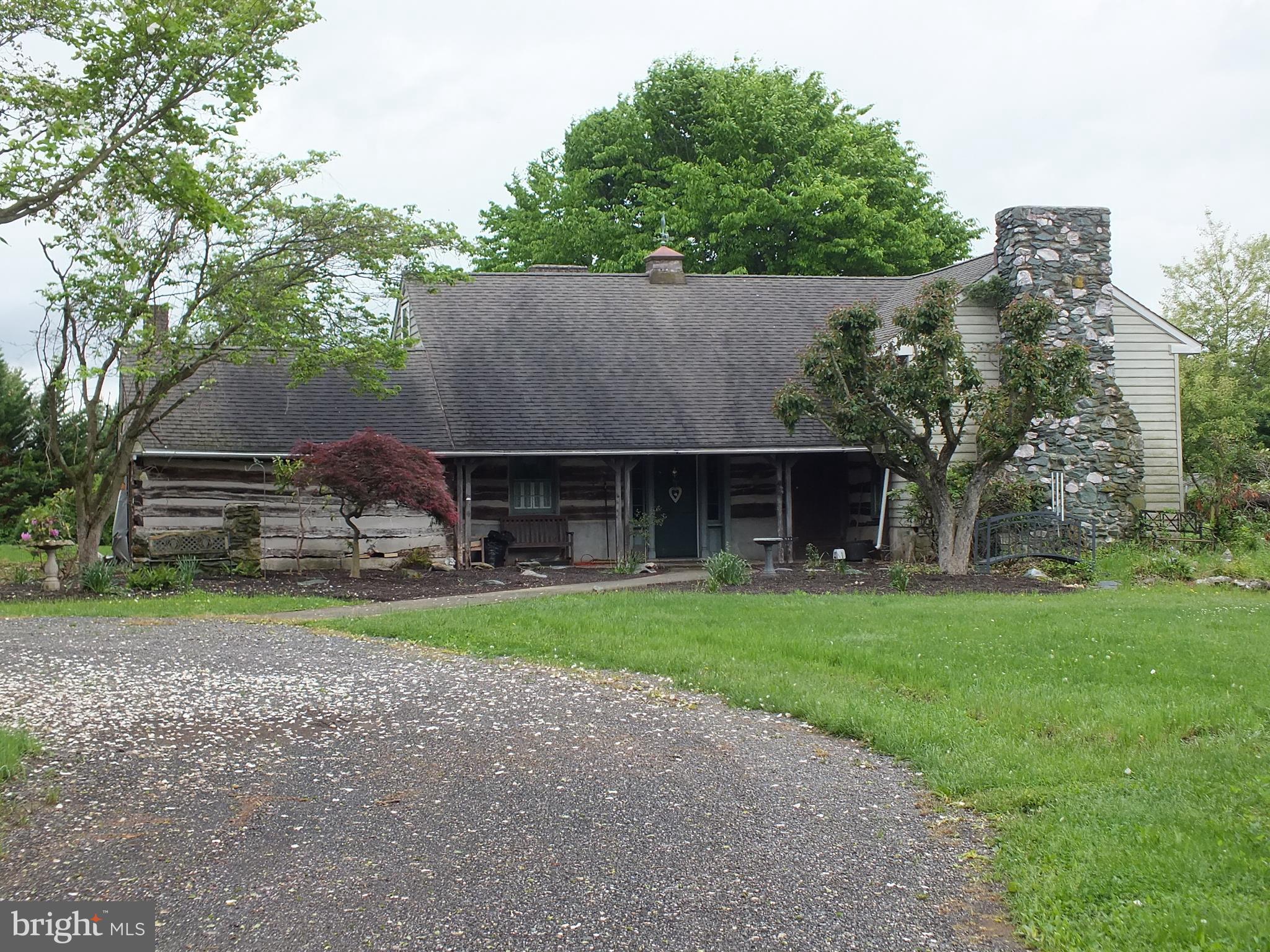 Beautiful, idyllic, park-like setting for this one of a kind log home nestled on 10 acres. It does need quite a bit of work to restore it to it's former beauty. There's a very large garage with attached workshop that's in very good condition. The wind turbine supplies electric to the property.