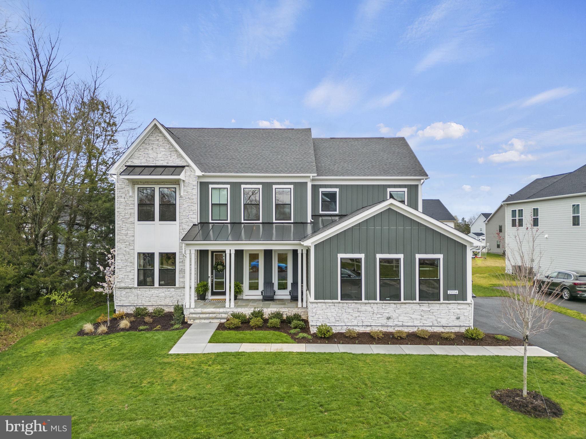 Welcome to 23934 Bigleaf Court, the epitome of luxury living in the esteemed Hartland community. This Richmond floorplan by DRB homes is situated on a premium lot, built in August 2023 with over $450,000 in upgrades from the builder and an additional $100,000 in post-sale updates. Your next home is a true showstopper where no detail has been left unturned. Upon entering, you'll be greeted by upgraded wide-plank luxury vinyl plank floors and exquisite Cristol by AERIN flush mount lights adorning the foyer ceiling. To the left, French doors open into a versatile sitting room or office adorned with a stunning chandelier from Crate and Barrel, while to the right, the formal dining room awaits, featuring a contemporary Restoration Hardware chandelier. Continue through the foyer into the magnificent living room, featuring a coffered ceiling, linear gas fireplace with Cashmere stone surround and mantel, and upgraded window package. The open floorplan seamlessly flows into the large Executive Gourmet Kitchen, showcasing Aristokraft Cabinets in Winstead Quill, a 13’X7’ center island with a KOHLER Neoroc® farmhouse sink, Desert Silver Quartz countertops, and Visual Comfort Piatto Large Pendant lights. Kitchen upgrades include a pot filler, Kitchenaid appliances, 6 burner gas stove and vent hood, and a breathtaking backsplash that adds a touch of elegance. Adjacent to the kitchen is a dining room with additional cabinet and storage space, complemented by a beautiful brass chandelier by Mcgee & Co. Step outside from the kitchen and family room to enjoy the Three-Season Screened porch with a linear gas fireplace, providing the perfect retreat from bugs and rain. The main level also features a beautifully designed mudroom with coat rack and cubbies, adjacent to the three-car, side-loading garage with epoxy floors. As you explore further, you'll notice the magnificent light fixtures throughout the home, handpicked from Restoration Hardware, Crate and Barrel, Visual Comfort, Aerin, and Studio McGee, creating ambience in every room.
Upstairs, discover the spacious primary bedroom boasting southeast-facing natural light, a walk-in closet, and a spa-like en-suite with dual vanities, frameless glass shower enclosure, herringbone tile, and a standalone soaking tub. The upper level also includes 2 guest bedrooms with en-suite bathrooms, featuring upgraded quartz countertops and tile that extends to the ceiling. Additionally, one bedroom has access to the hall bath with a shower-tub. The laundry room is conveniently nestled between the bedrooms, making washing clothes an easy chore. Downstairs, the basement offers even more living space with 9’ ceilings in the finished rec room, playroom, media room, bedroom, and full bathroom. The wet bar in the rec room is equipped with a beverage fridge and sink, perfect for entertaining guests. Hartland offers a plethora of amenities, including Verizon gig-speed internet, lifestyle programming and events, maintenance and landscaping of common areas, and trash/recycling pickup. Residents can also enjoy an outdoor pool, fitness center, winery, and numerous jogging and walking trails. Every detail in this home has been thoughtfully curated. Experience the unparalleled luxury and convenience of living at 23934 Bigleaf Court, the greatest home in Aldie.