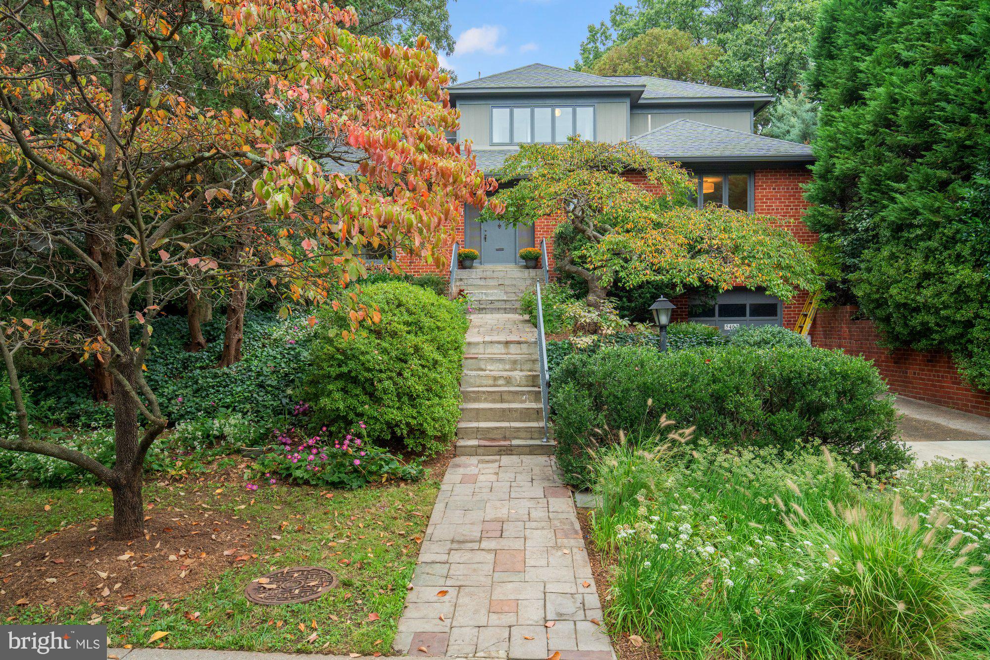 This inviting Somerset residence has been lovingly maintained by the same family for more than 40 years. Thoughtfully expanded in the 1990s, the home offers five bedrooms and four full bathrooms across three finished levels, blending timeless character with versatile living spaces.

The main level welcomes you with the warmth of hardwood floors and a bright living room anchored by a fireplace and expansive front window. The dining room opens onto a deck overlooking the rear garden, while the adjoining kitchen and breakfast room provide a comfortable setting for everyday living. Three bedrooms, including one that works beautifully as a den or office, along with two full bathrooms, complete this floor.

Upstairs, the private primary suite serves as a true retreat, featuring a spacious sitting area, two large closets, a spa-like bathroom, and a balcony with sweeping garden views. An additional open space on this level offers flexibility for use as an office, study, or playroom.

The lower level extends the living space with two large recreation rooms ideal for gatherings, hobbies, or casual evenings at home. A fifth bedroom and full bathroom, laundry facilities, and direct access to the attached one-car garage complete this level.

What makes this property especially distinctive are its grounds. Mature plantings, lush greenery, and blooming perennials create a natural sanctuary—a private oasis for outdoor living and quiet enjoyment. Whether dining on the deck, entertaining on the lawn, or simply savoring the view from the upstairs balcony, the gardens provide a serene backdrop in every season.

The Town of Somerset offers something rare: small-town charm with urban convenience. Somerset provides amenities not found in neighboring communities, including a community pool, tennis courts, dedicated snow and trash removal, and a town arborist who maintains the canopy of mature trees. Daily life in the town is easy and connected. A neighborhood path leads to Norwood Park and the Capital Crescent Trail, while Friendship Heights Metro, shopping, dining, and entertainment are just minutes away. More than anything, Somerset is known for its spirit of community—neighbors become lifelong friends, and many residents stay for decades, drawn by a warmth and convenience that is truly unmatched in the Washington area.
