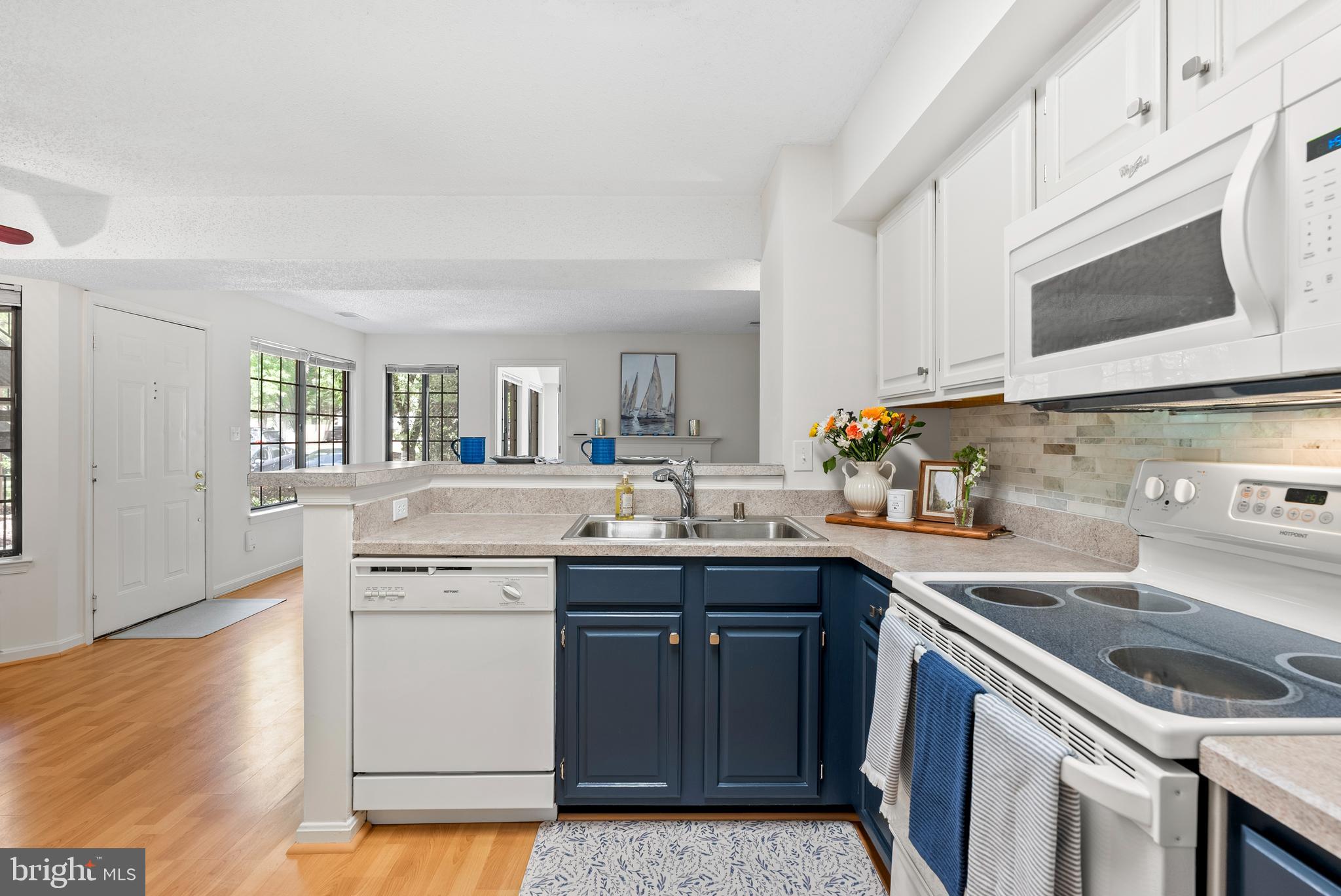 This beautiful 2 BR garden condominium exudes charm and a like-new ambience!  Ideally situated in the lovely Tiers of Walden, offering the Walden clubhouse, golf, pool and tennis.  Mature landscaping abounds in a park-like setting.  Enjoy al fresco meals on the patio with songbirds and hollies. The open, light-filled floorplan welcomes you with modern finishes and amenities.  The bright, cheerful kitchen with breakfast bar offers newer appliances, new ceramic backsplash and fresh cabinetry, opening onto a cozy firelit living room.   Lovely resilient flooring, freshly painted interiors, hew hardware and soaring ceilings.  A new coastal-inspired ceramic bath is uplifting and sparkling.  Low condo fee includes water.  So-well located near all of the Waugh Chapel and Crofton conveniences and commuting thoroughfares with excellent proximity to both Washington and Baltimore metro areas.  Dining, shopping, parks and more are all just minutes away!