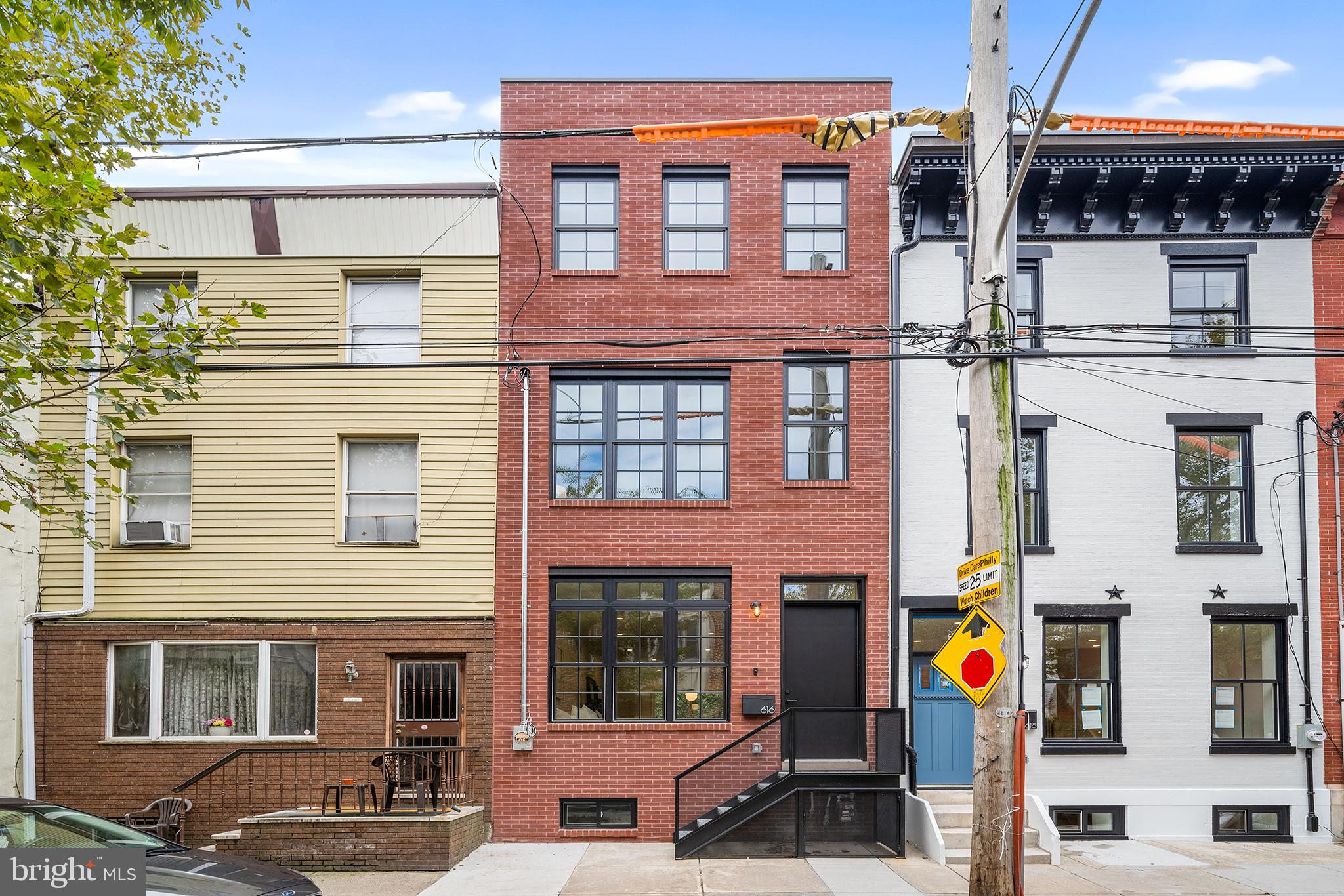 Welcome to 616 Catharine Street, a luxurious, new construction home in the heart of Bella Vista on arguably one of the nicest blocks in Philadelphia.  This stylish, impeccably built, 4 Bedroom, 4 Bathroom home boasts roughly 3,000/SF of living space, 10 foot ceilings, and an approved 10 Year Tax Abatement! Walk through the front door into an amazing, modern living space with wide plank white oak flooring throughout. Walk through the dining area and into the custom kitchen of your dreams. Modern black & walnut cabinets highlighted with Thermador stainless steel appliances, floating shelves and black leathered granite countertops. Step through the sliding glass door and into serenity. A stone paver patio shaded by mature trees creates this roughly 40' deep private oasis.  Indoor/outdoor living at its finest! Upstairs you will find an ensuite bedroom that gets both sun and shade from the trees through large windows with its own modern bathroom.  In the hallway is a full size laundry room, complete with storage cabinets and a countertop for folding. Just down the hall is another sleekly tiled bathroom with a tub and a bedroom that gets amazing light from the oversized windows. The entire 3rd floor hosts the Primary Suite with an expansive bedroom and large, custom walk-in closet with plenty of storage for even the most extensive wardrobes.  Enjoy your morning cup of Joe or nightcap from the bedroom terrace that overlooks your incredible rear yard.  The Primary Bath is a showstopper. Large format gray, veined porcelain tile runs floor to ceiling and is accented nicely by a 72” white oak double vanity, matte black fixtures, a free standing soaking tub and a huge 2 piece shower.  The roof deck tops it all off with 360 degree city views and an outdoor kitchenette with a refrigerator. Perfect for entertaining!  The fully finished basement with high ceilings provides an additional living space, a full bathroom, a storage closet and a 4th bedroom. Recessed LED lighting, Andersen windows, spray foam insulation, and NEST controlled multi-unit HVAC help make this home smart and energy efficient. With a WalkScore of 99, 616 Catharine Street is a “Walker’s Paradise”.  You are within a short stroll to Bella Vista’s best amenities; Shot Tower Coffee, Angelo’s Pizzeria, Saloon, Fitzwater Cafe, John’s Water Ice, the Italian Market, Square Pie and so much more. It’s also just blocks away from Center City for an easy commute to work. Don’t miss your chance to own a home on this picture perfect block.
