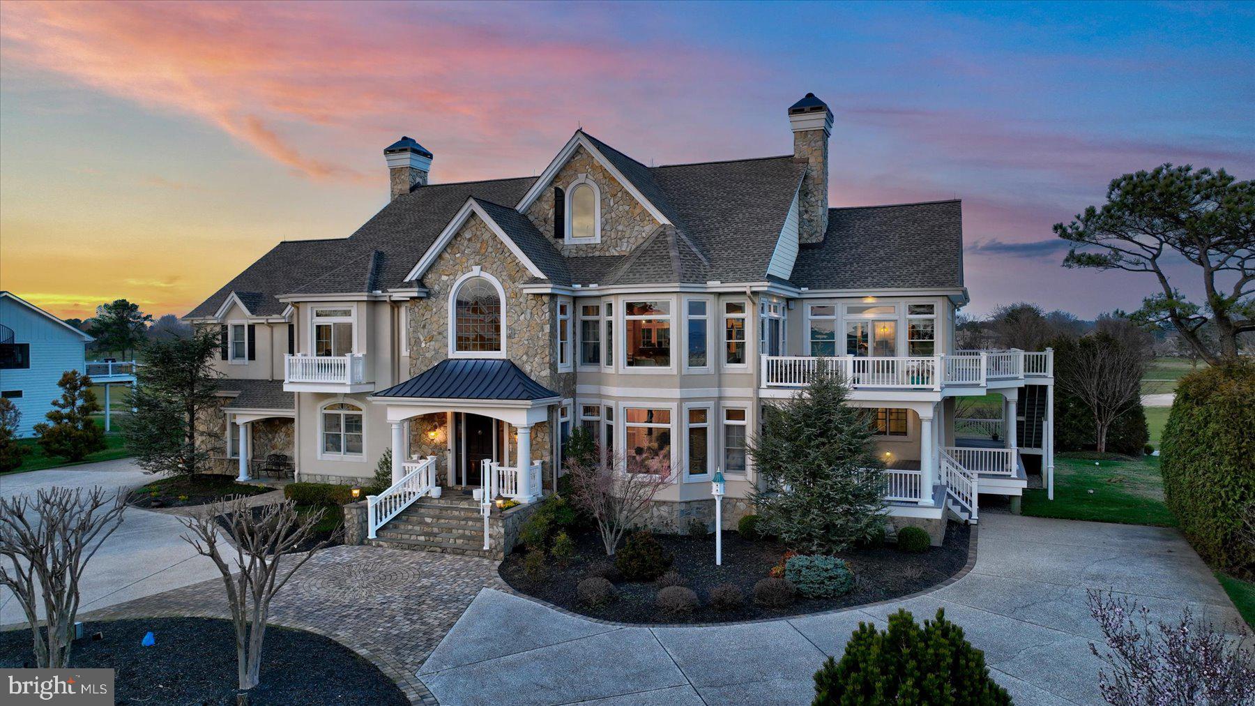 Introducing “The Big Easy” in Rehoboth Beach Yacht and Country Club. Rarely does an elegantly informal home like this become available. This remarkable golf course front Smart Home offers a lifestyle that dreams are made of. With breathtaking panoramic views of the 10th, 17th, and 18th holes, as well as the Rehoboth Bay, this home's location is truly unparalleled. Upon arrival, you'll be greeted by an inviting two-story foyer that sets the tone for what lies beyond. This home is bathed in natural light, creating a feeling of warmth and serenity. Ascend the grand staircase, or use the elevator, to the heart of the home, the great room, featuring a magnificent stone fireplace that beckons gatherings and cozy evenings by the fire. But it's the sunroom that steals the show, a sanctuary of tranquility where you can immerse yourself in your favorite book while being enveloped by the shimmering waterscape that greets you, every day in every season. Step outside onto the sun deck and enjoy the direct bay views. Here, you'll find the perfect spot to unwind, entertain, and savor the beauty of your waterview oasis. The upper level also boasts a golf course front primary suite that is nothing short of a personal sanctuary, complete with easy access to the Charleston style decks. Additionally, on this level, is a home office, a large dining room, and a welcoming gourmet designer kitchen. Descend the stairs, or use the elevator to the main level to discover a living room, three additional primary suites, a gym with sauna and steam shower, a large office, and an over-sized 3-car garage.
********
For those seeking a premier country club lifestyle, the option of a private membership awaits (contact for further details on RBCC membership). Just steps away lies the Rehoboth Beach Country Club clubhouse, where you can indulge in superb dining options, a bayfront pool, a state-of-the-art fitness center, tennis, pickleball and an impressive 18-hole Championship golf course.********

This golf course front gem with unobstructed bay views is more than a home; it's a lifestyle opportunity that simply cannot be replicated. Don't miss your chance to make this incredibly special retreat your own. Quality, informal elegance, and views like this are a rarity.  Seize this extraordinary opportunity and experience the best of coastal club living.